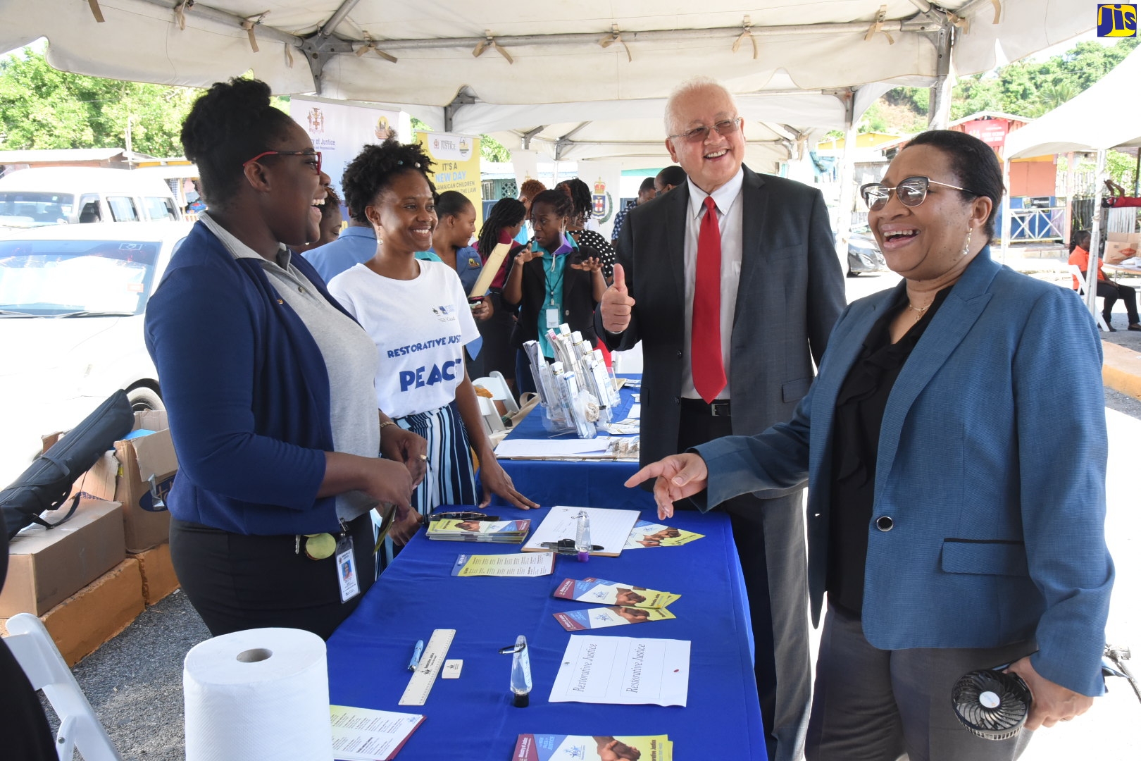 Justice Minister, Hon. Delroy Chuck (second right), and Permanent Secretary in the Ministry of Justice, Grace Ann Stewart McFarlane (right) interact with Restorative Justice Liaison Officer, Melissa Archer (second left), and Restorative Justice Parish Officer, Tashana Smith, at a Legal Aid Council Justice Fair in Lucea, Hanover, on Friday (September 23).