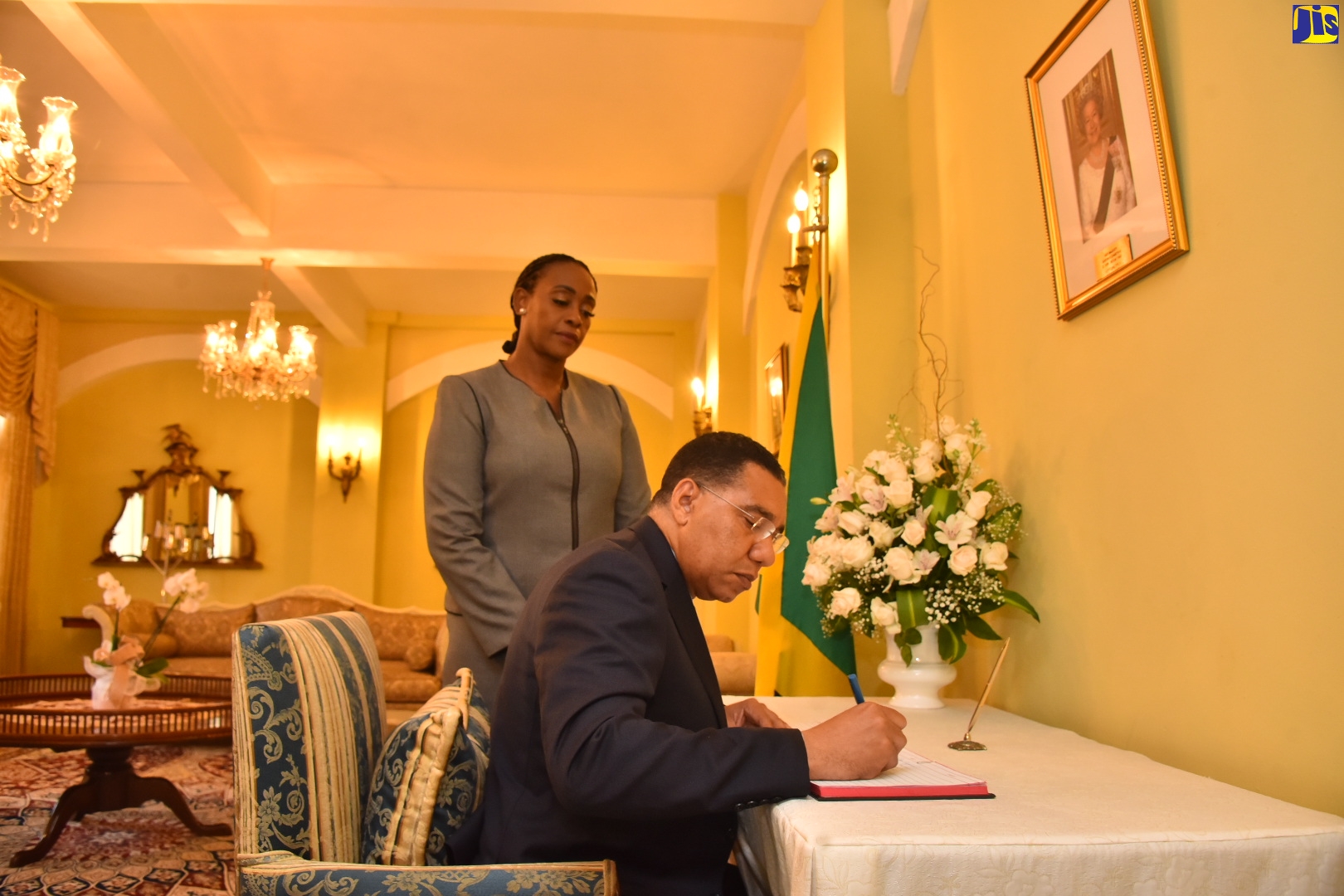 Prime Minister, the Most Hon. Andrew Holness (right), signs the Condolence Book opened at King’s House for Great Britain’s late Monarch, Her Majesty, The Queen. Observing is wife of the Prime Minister and Deputy Speaker of the House of Representatives, the Most Hon. Juliet Holness. Both officials signed the Book on Monday (September 12).