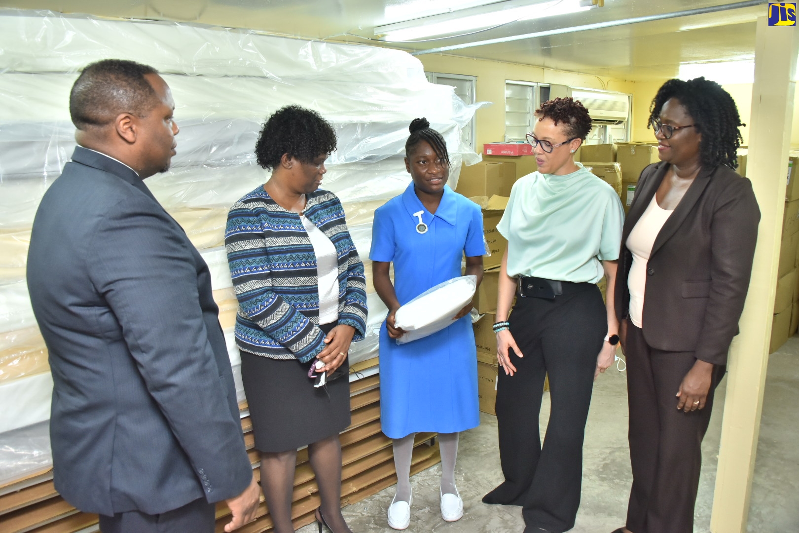 Student Nurse, Kenesha Simms (centre), holds a package containing medical supplies donated to member institutions of the Council of Community Colleges of Jamaica (CCCJ), during a ceremony at Excelsior Community College in Kingston on Tuesday (September 20). She is joined by (from left) Director of Citizen Security, United States Agency for International Development (USAID) Jamaica, Gerald Fontain; Executive Director, CCCJ, Dr. Donna Powell Wilson; Vice Principal of Academic Affairs and Institutional Advancement, Excelsior Community College, Zaria Malcolm Walker; and Donor and Partnership Officer, National Education Trust (NET), Simone Griffith. The items, inclusive of masks, sanitisers, thermometers, gloves, gowns, and relief beds, were donated by FHI 360 in partnership with Project C.U.R.E through the Advance Program. 