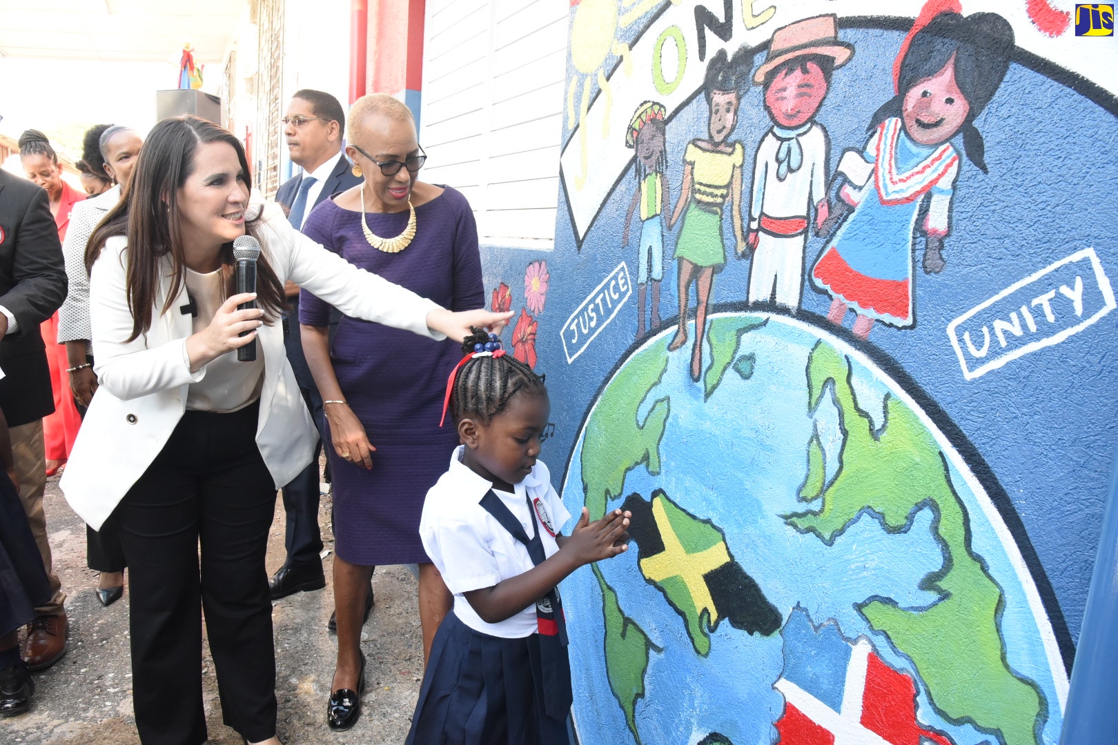 Minister of Education and Youth, Hon. Fayval Williams (right), looks on as Ambassador of the Dominican Republic, Her Excellency Angie Martinez (left), explains the significance of the mural that was unveiled at the Franklin Town Primary School in Kingston, which has been adopted by the Embassy of the Dominican Republic. Also looking on is student, Khalia Evans. The mural was part of the facelift gifted to the school by the Embassy  and represents friendship between the two countries. The ceremony was held on Monday, September 5.

