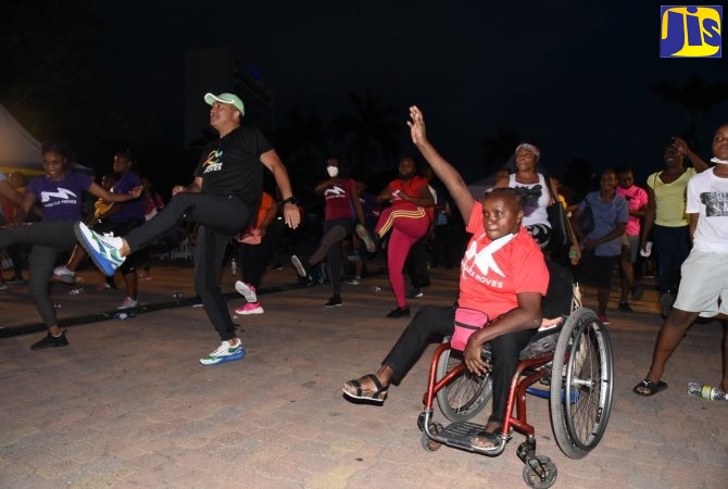 Minister of Health and Wellness, Dr. Hon. Christopher Tufton, is joined by members of the public in a workout session during the recent launch of Caribbean Moves at Emancipation Park, St. Andrew.