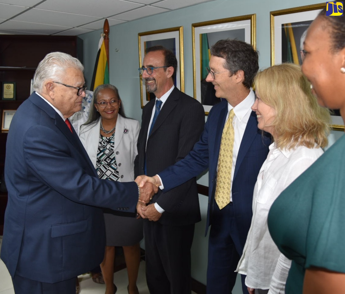 Minister of Labour and Social Security, Hon. Karl Samuda (left), greets the World Bank’s Human Development Programme Leader for the Caribbean and Haiti, Timothy Johnston (third right), when he hosted a meeting with a team from the multilateral institution on Wednesday (September 21), at the Ministry’s offices in downtown Kingston. Others (from second left) are: Permanent Secretary in the Ministry, Colette Roberts Risden; and World Bank representatives, Human Development Regional Director for Latin America and the Caribbean, Dr. Luis Benveniste; Deputy Country Director for Caribbean Countries and Country Management Unit Operations Manager, Gail Richardson; and Programme Assistant, Rachel Whitely.