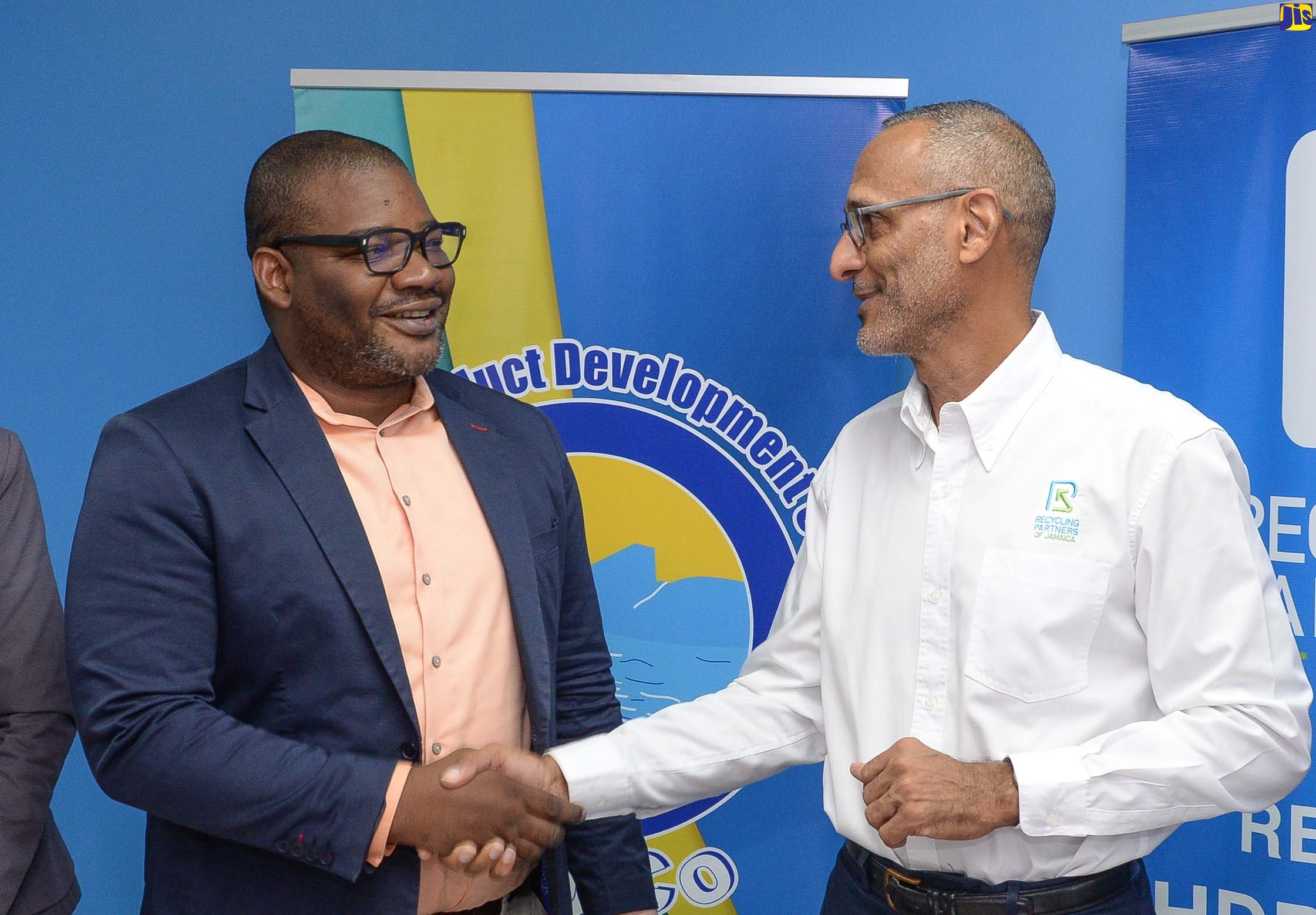 Executive Director, Tourism Product Development Company Limited (TPDCO), Wade Mars (left), shakes hands with Chairman, Recycling Partners of Jamaica (RPJ), Dr. Damien King, following the signing of a Memorandum of Understanding (MOU) between the entities to extend the Tourism Sector Recycling Partnership to resort areas in Kingston and the South Coast. The signing took place on Thursday (September 22) at RPJ’s head office in Kingston.
