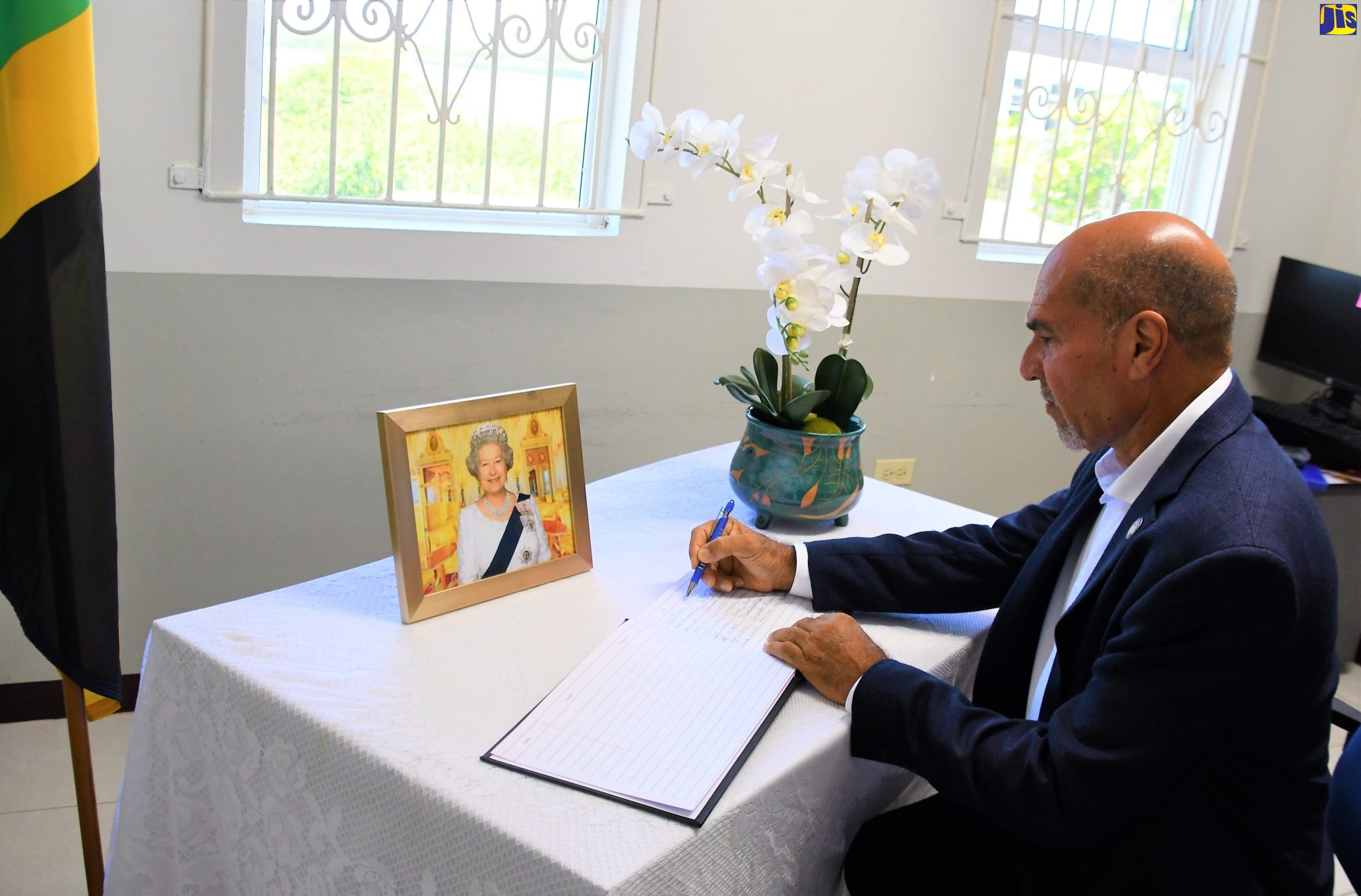Custos of Trelawny, Hugh Gentles, signs the Condolence Book for Her Majesty, The Queen at the Office of the Custos in Falmouth on Friday, September 16. 
