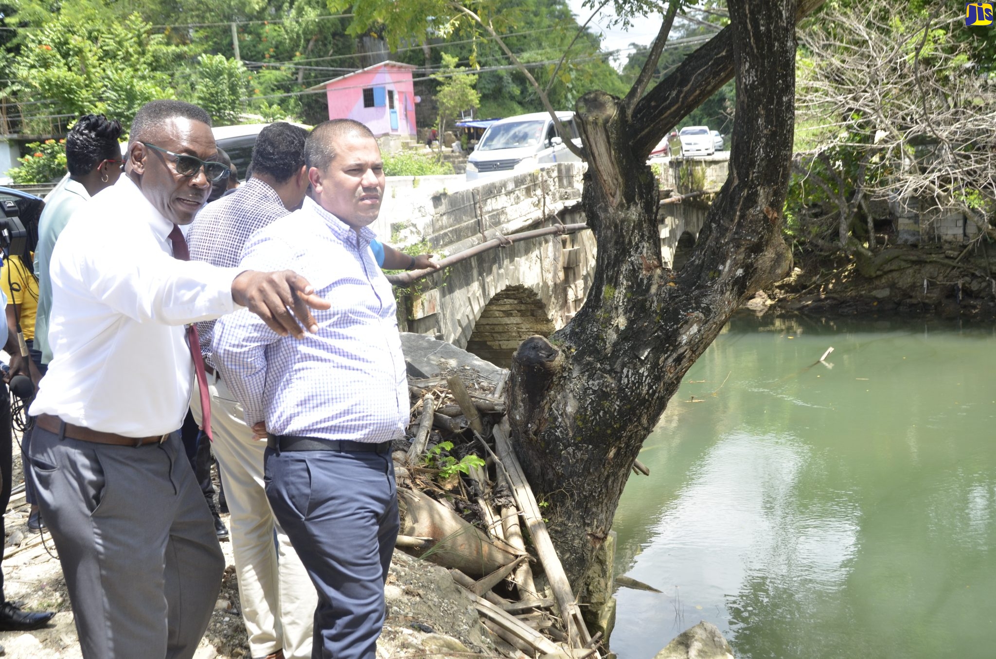 Councillor for the Lucea Division, Easton Edwards (left),  points out to Minister without Portfolio in the Ministry of Economic Growth and Job Creation, Senator the Hon. Matthew Samuda, areas on the Riley River that contributed to the flooding of Lucea during recent rains. Councillor Edwards and the Hanover Parish Development Committee (HPDC) will coordinate the clearing of bamboo and other debris from the Riley River on International Coastal Clean-up Day, Saturday, September 17. 

