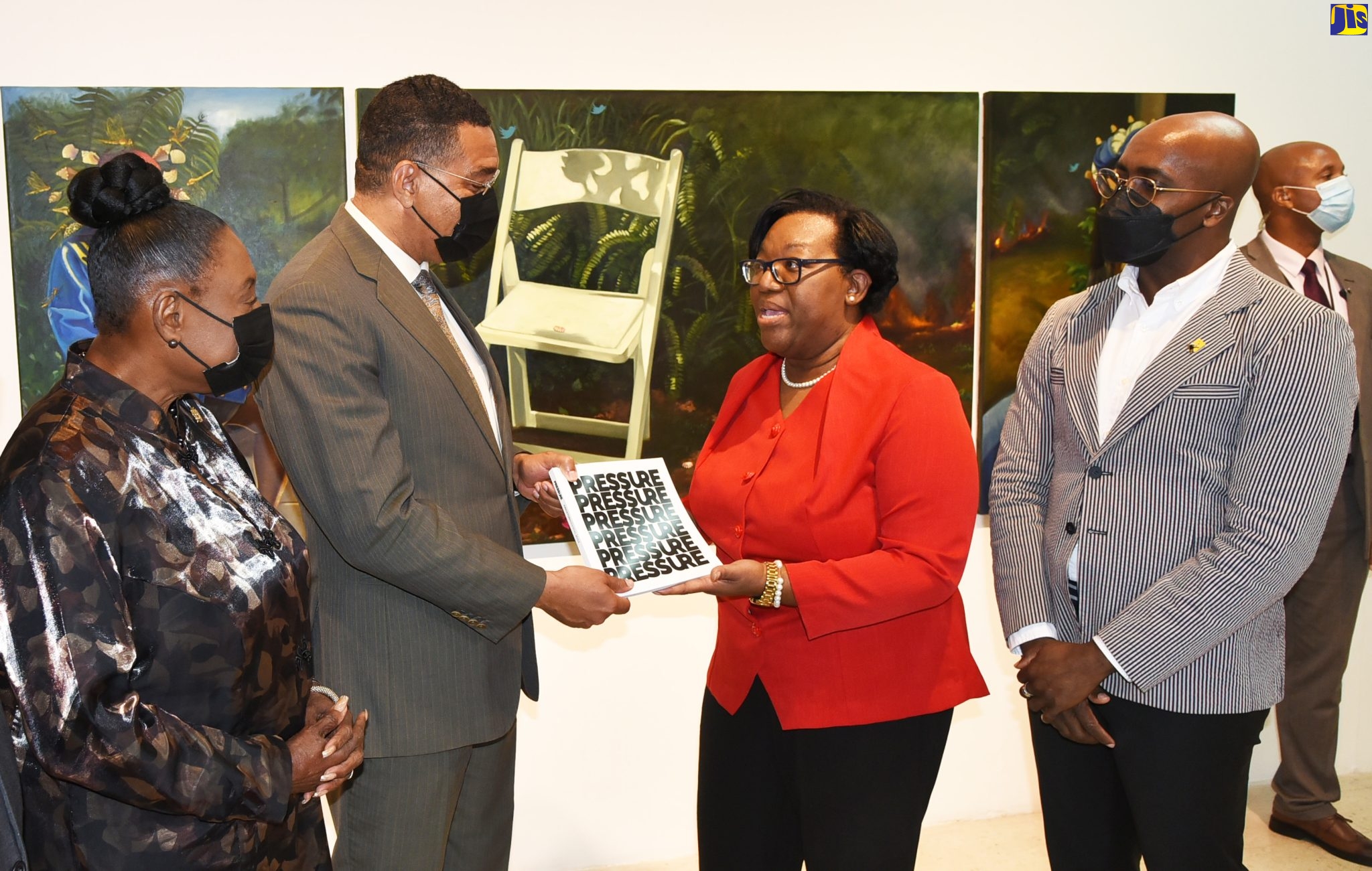 Prime Minister, the Most Hon. Andrew Holness (second left), accepts a catalogue of the exhibition -‘Kingston Biennial 2022: Pressure’ - from Senior Director of the National Gallery of Jamaica (NGJ), Roxanne Silent (second right), following his tour of the display at the NGJ on Thursday (September 8). Looking on (from left) are Minister of Culture, Gender, Entertainment and Sport, Hon. Olivia Grange,  and Chief Curator, NGJ, O’Neil Lawrence.
