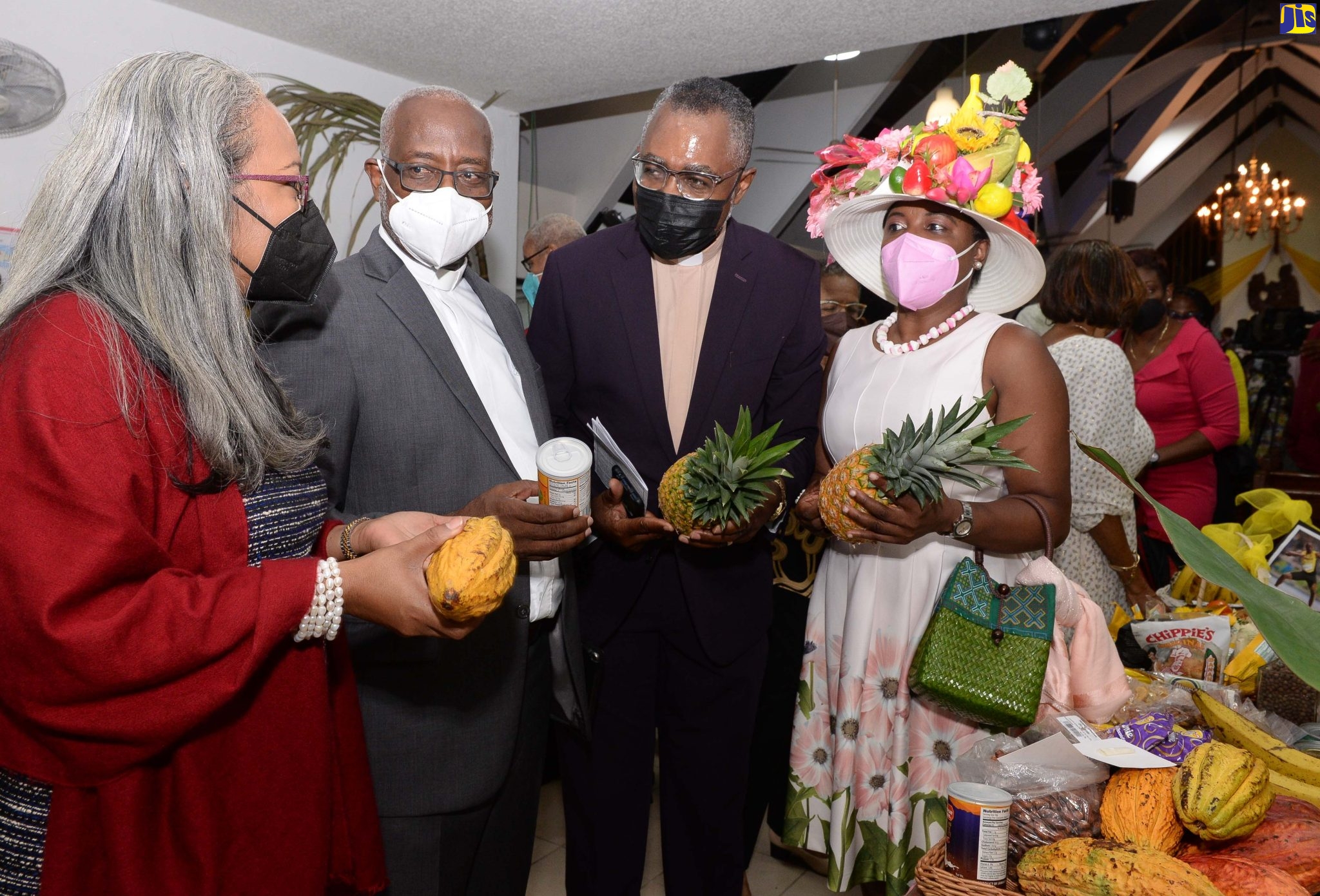 Permanent Secretary at the Ministry of Labour and Social Security, Colette Roberts Risden (left) along with others (from second left), Rev. Dr. Henroy Samuels; Host Minister at the Webster Memorial United Church, Rev. Delroy Harris; and former chairperson, Webster Memorial United Church Harvest Planning Committee, Andrea C. Whyte, view the fruits displayed at the Church in Kingston on September 25.