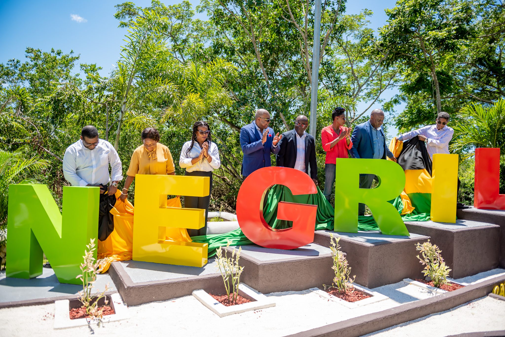 Tourism Minister, Hon. Edmund Bartlett (fourth left), leads the applause at the unveiling of the new welcome sign for the resort town of Negril on September 9. Others sharing the moment (from left) are Executive Director, Tourism Product Development Company (TPDCo), Wade Mars; Secretary Manager, Negril/Green Island Area Land Authority, Althea McKenzie-Stewart; Hanover Western Member of Parliament, Tamika Davis; Lucea Mayor, Councillor Sheridan Samuels; Lucea Deputy Mayor, Councillor Andria Dehaney Grant; Savanna-la-Mar Deputy Mayor, Councillor Danree Delany; and Negril Chamber of Commerce President, Richard Wallace.   