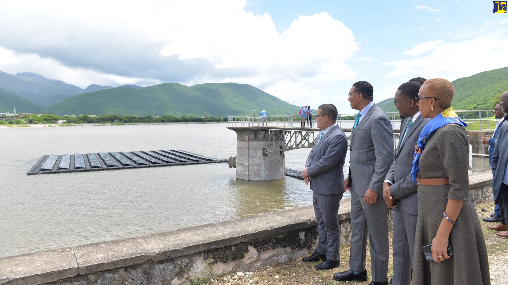 Prime Minister, the Most Hon. Andrew Holness (second left), looks at a  demonstration of a floating solar panel at the Mona Reservoir in St Andrew. Joining him (from left) are Minister without Portfolio in the Ministry of Economic Growth and Job Creation, Senator the Hon. Matthew Samuda; Minister without Portfolio in the Office of the Prime Minister with Responsibility for Information, Hon. Robert Morgan; and Minister of Education and Youth and Member of Parliament for St. Andrew Eastern, in which the Reservoir is located, Hon. Fayval Williams. Occasion was a launch event for a 45-megawatt floating solar project at the reservoir on Wednesday (September 28).