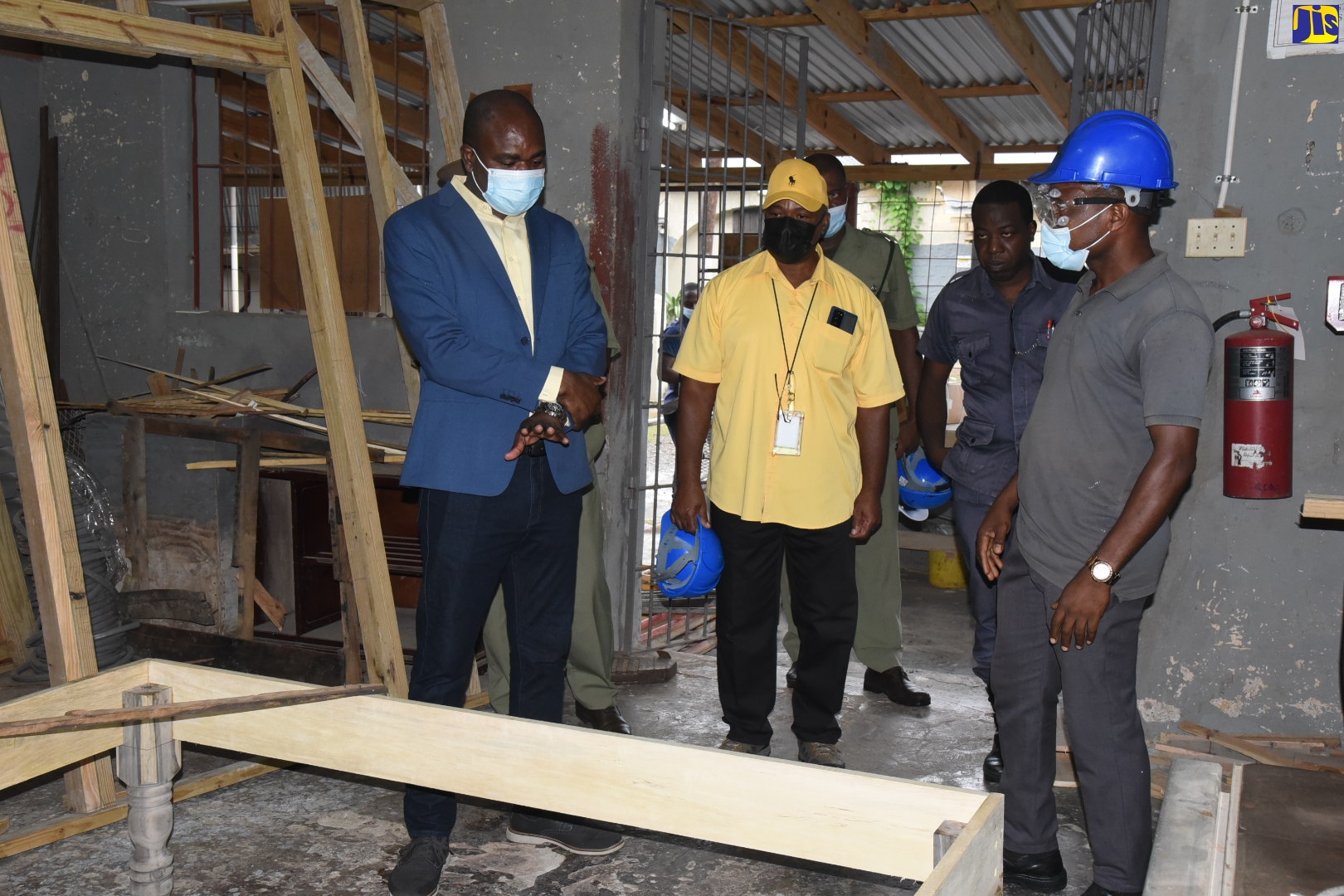 Minister of State in the Ministry of National Security, Hon. Zavia Mayne (left), and Commissioner of Corrections, Lieutenant Colonel (Ret’d) Gary Rowe (second left), observe work being done at the Richmond Farm Correctional Centre during a tour of the facility on Thursday (September 1).