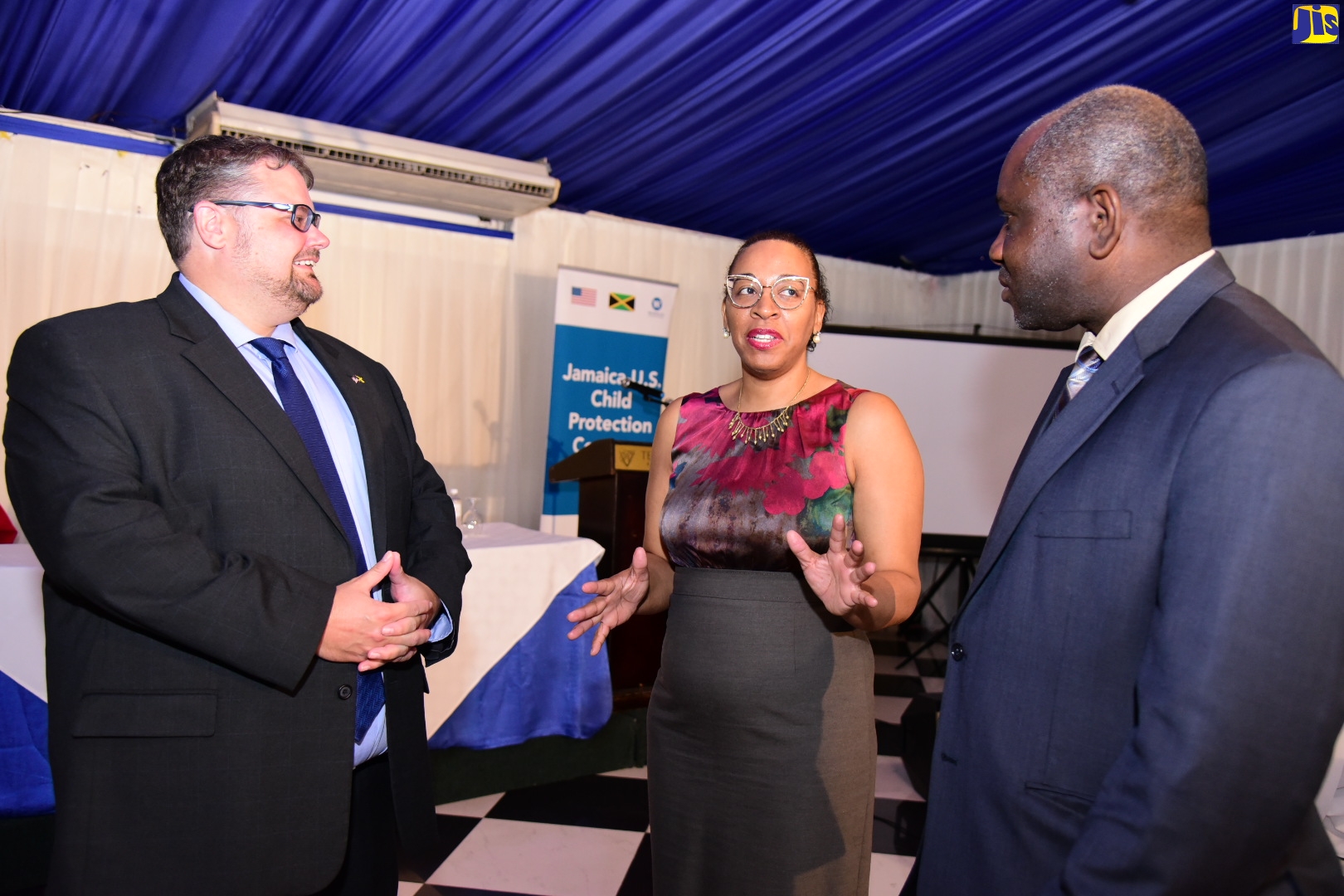 Chair, National Task Force Against Trafficking in Persons (NATFATIP) and Permanent Secretary in the Ministry of National Security, Courtney Williams (right), converses with (from left) Political and Regional Team Lead, and NATFATIP Representative, United States (US) Embassy in Jamaica, Scott Winton, and Project Director, Jamaica-US Child Protection Compact (CPC) Project, Nasolo Thompson. Occasion was the closing out ceremony for Winrock International’s Trafficking in Persons Project, at the Terra Nova All-Suite Hotel in St. Andrew on Wednesday (October 19). Winrock International is a US-based nonprofit organisation that works with people around the world to empower the disadvantaged, increase economic opportunity, sustain natural resources, and protect the environment.