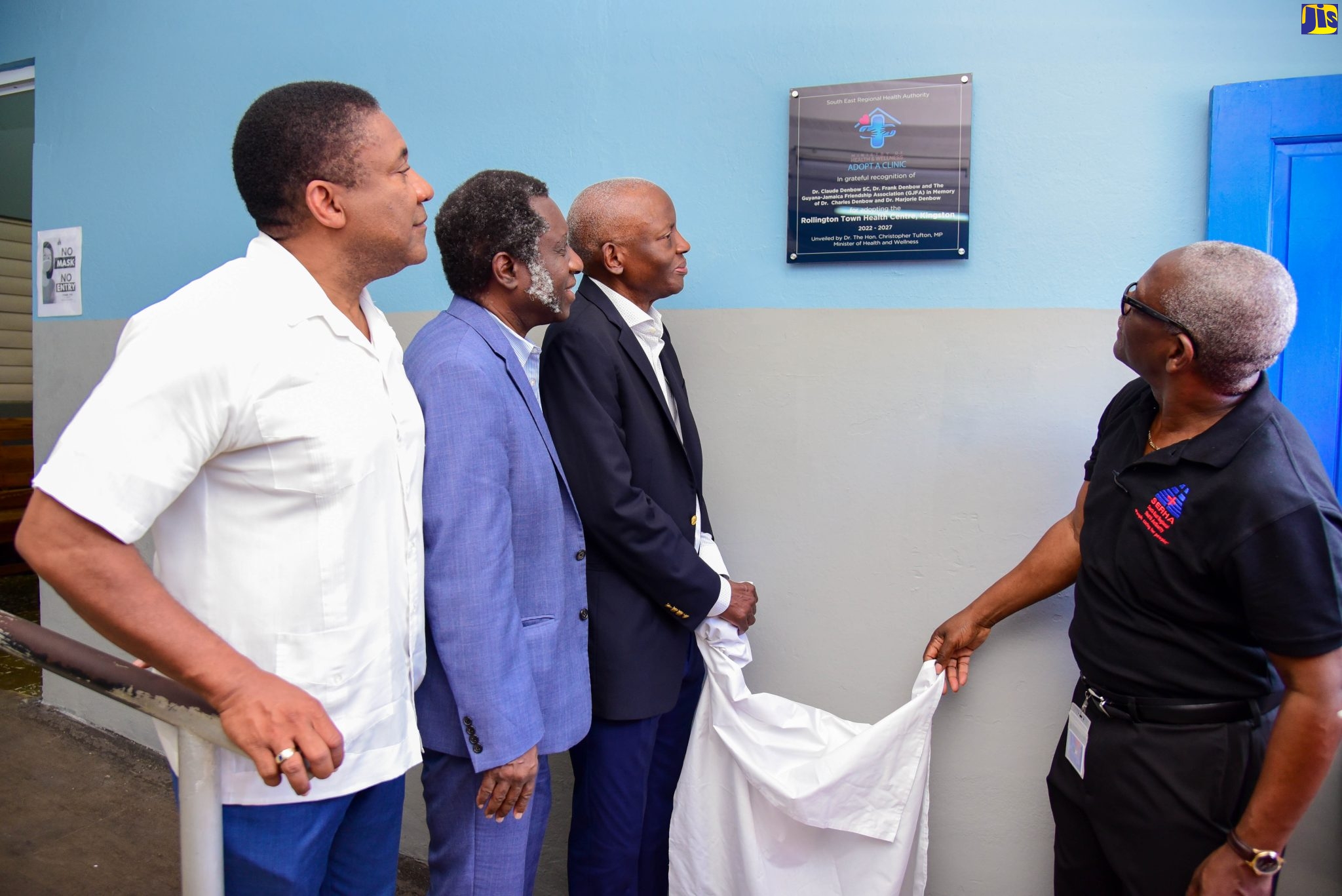 South East Regional Health Authority (SERHA) Chairman, Wentworth Charles (right) and donor partner, Dr. Claude Benbow (second right), unveil a commemorative plaque for the adoption of the Rollington Town Health Centre in Kingston, during the adoption ceremony on October 21. Also participating (from left) are Member of Parliament for Kingston East and Port Royal, Phillip Paulwell, and co-donor partner, Dr. Frank Denbow. The clinic has been adopted by the doctors along with the Guyana-Jamaica Friendship Association. 