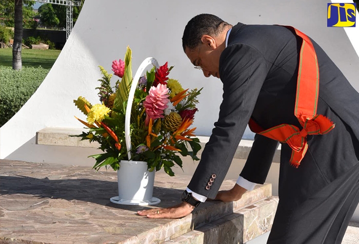 Prime Minister, the Most Hon. Andrew Holness, lays a floral tribute for National Hero, the Rt. Excellent Sir Alexander Bustamante at National Heroes Park in Kingston on Monday, October 17.