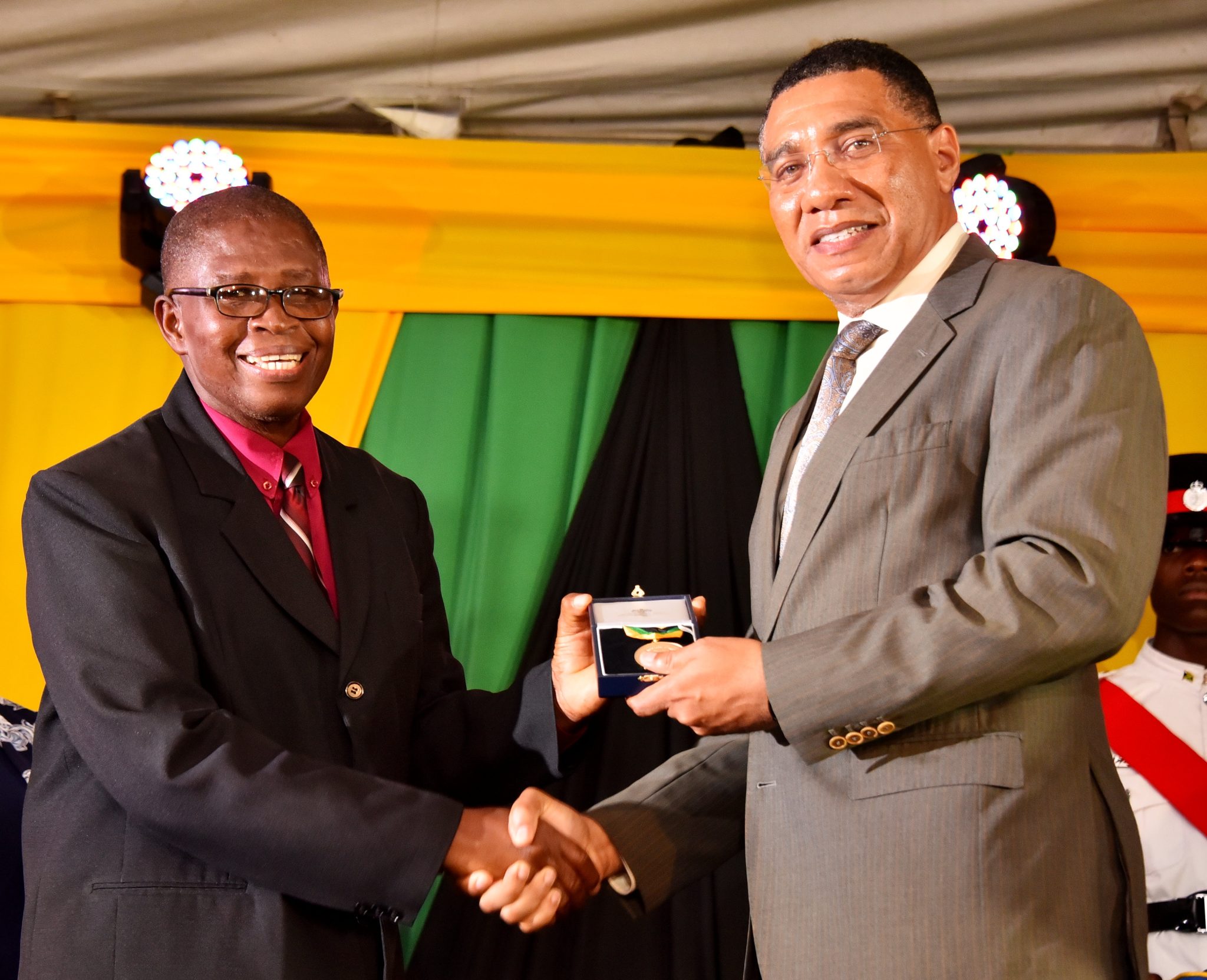 Prime Minister, the Most Hon. Andrew Holness (right), presents a Medal of Appreciation to retired Principal of Keith Primary and Infant School in St. Ann, Radcliffe Knox Gordon, in recognition of his outstanding service to education. The presentation was made during a ceremony at Jamaica House on September 8.

