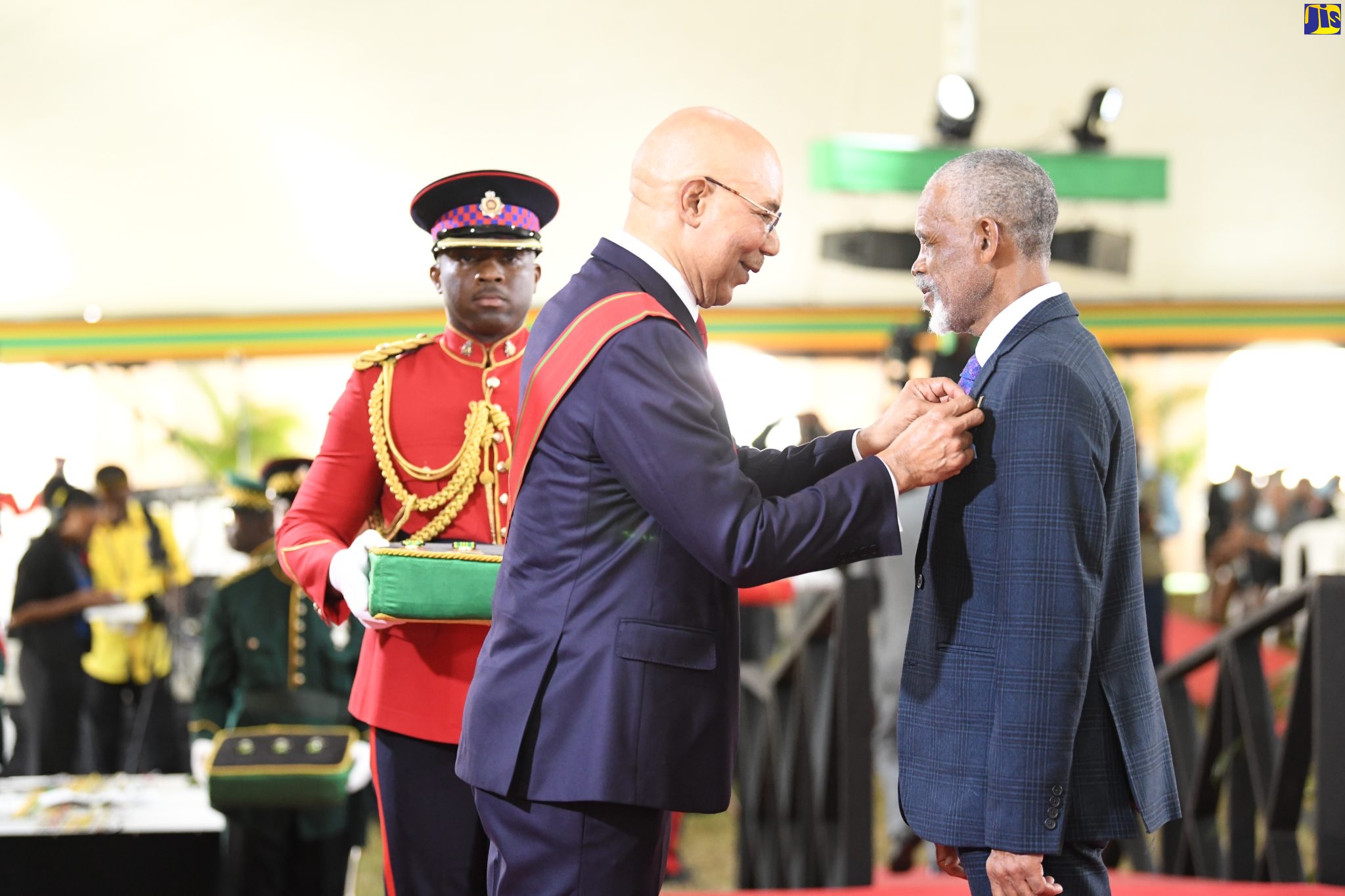 Governor General, His Excellency the Most Hon. Sir Patrick Allen (left), pins Chief of the Moore Town Maroons in Portland, Colonel Wallace Sterling, with the Order of Distinction (Officer Class), for the promotion and protection of maroon heritage in Jamaica, at the National Honours and Awards ceremony, held yesterday (October 17), at King’s House, in Kingston.