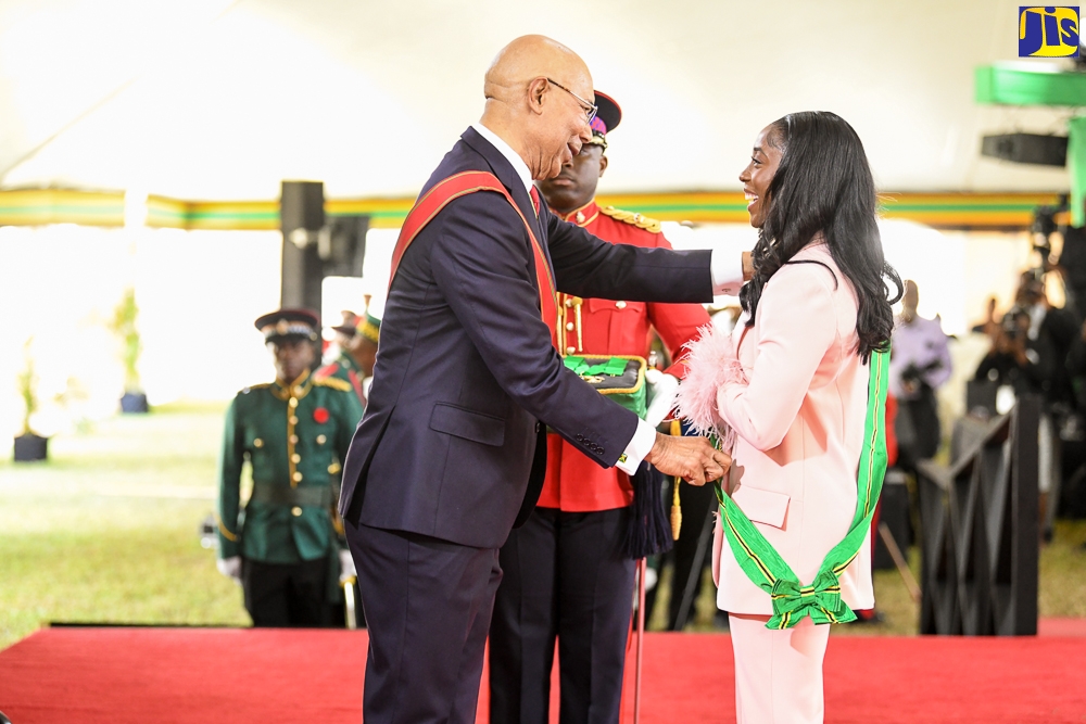 Governor-General, His Excellency, the Most Hon. Sir Patrick Allen (left), presents Olympian Shelly-Ann Fraser Pryce, with  the Order of Jamaica (OJ) for outstanding performance in the field of athletics at the international level, during the National Honours and Awards presentation ceremony held at King’s House on Monday (October 17).