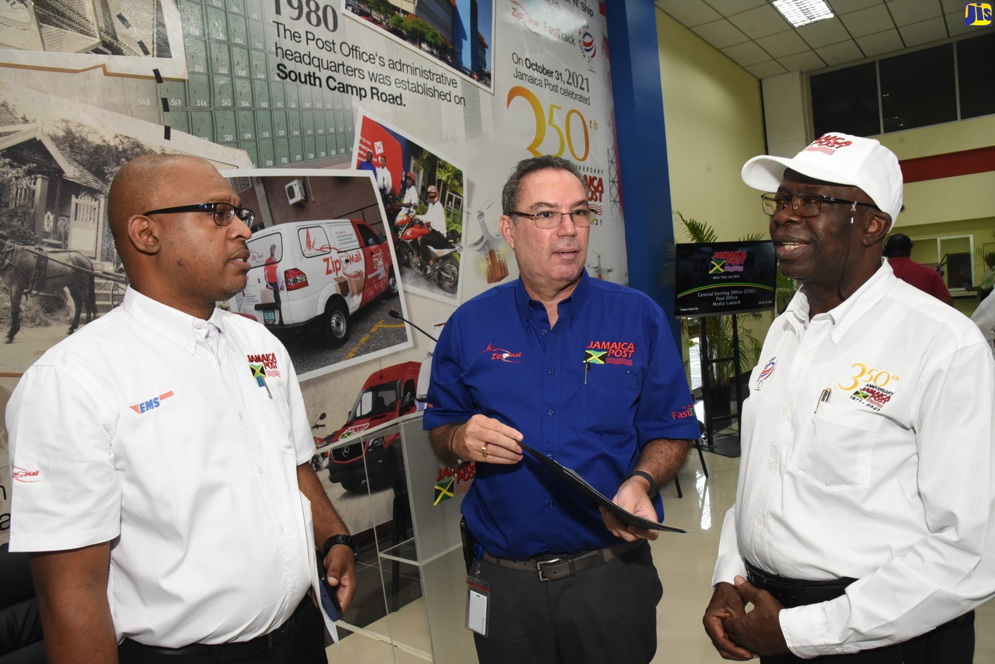 Minister of Science, Energy and Technology, Hon. Daryl Vaz (centre), in dialogue with Chairman of the Postal Corporation of Jamaica, Professor Felix Akinladejo (right), and Postmaster General of Jamaica Post, Lincoln Allen, at the official reopening of the renovated Central Sorting Office (CSO), South Camp Road, in Kingston, on October 13. The CSO Post Office is the first of 24 post offices to be designated National Identification System (NIDS) enrolment centres across the island.