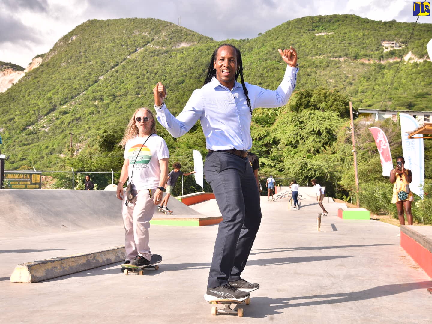 State Minister in the Ministry of Culture, Gender, Entertainment and Sport, Hon. Alando Terrelonge (right), shows off his skateboarding skills, at the opening of the Freedom Skatepark at Eight Mile in Bull Bay, St. Andrew, on Wednesday (October 13). Looking on in the background is Chief Executive Officer (CEO), Jamaica Skate Culture Foundation, Remy Walker. Built at the start of the 2020 Covid-19 pandemic, Freedom Skatepark has been a haven for young people in and around Bull Bay to be actively engaged in social development programmes, advancing their academic studies through its homework programme, learning music and art,  and building confidence, all while enjoying and improving their skills in the sport of skateboarding.  The project involves partnership with Sandals Foundation. 