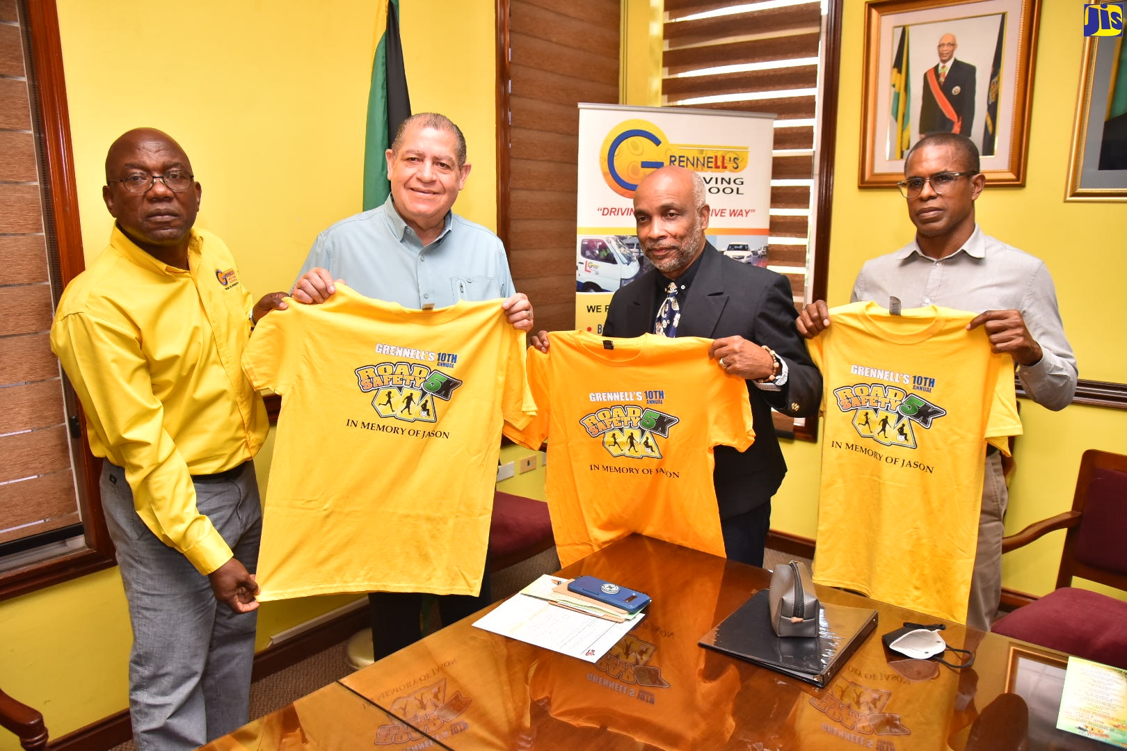 Transport and Mining Minister, Hon. Audley Shaw (second left), displays a Grennell’s Driving School emblazoned T-shirt during the launch of the company’s 10th annual ‘Road Safety 5K’ on Thursday (October 13), at the Ministry’s Maxfield Avenue location, Kingston. Also pictured (from left) are Managing Director, Grennell’s Driving School, Alphonso Grennell; President, Jamaica Olympic Association, Christopher Samuda; and Chief Medical Officer Sir John Golding Rehabilitation Centre, Dr. Rory Dixon. The event seeks to raise road-safety awareness. Proceeds from the 5K race will be donated to the Sir John Golding Rehabilitation Centre.