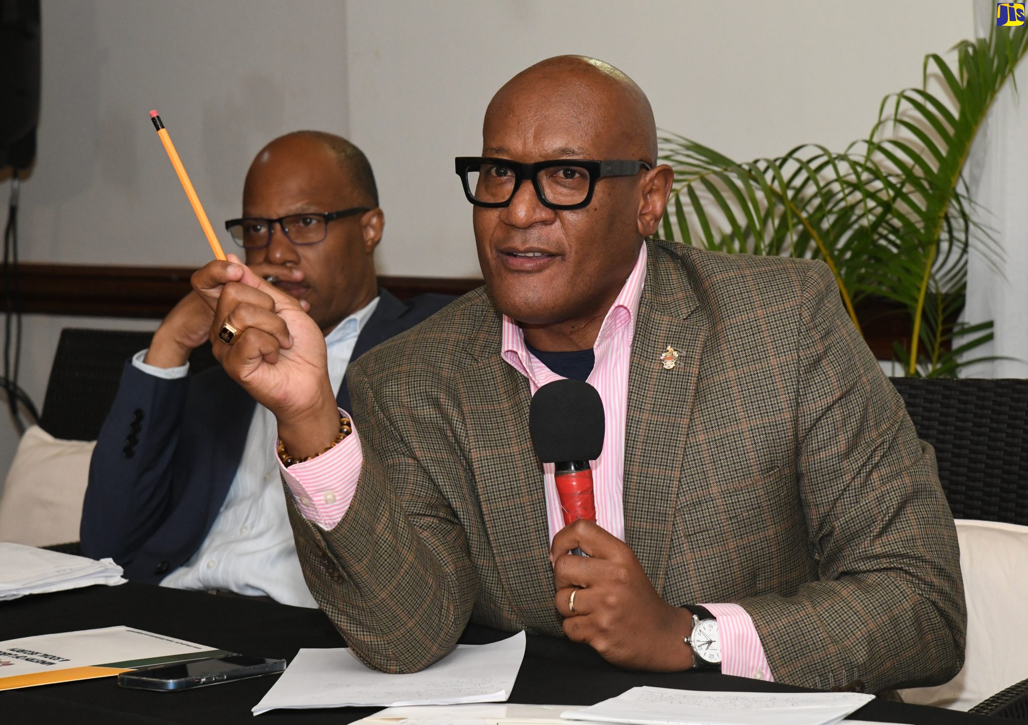 Chairman, National Minimum Wage Advisory Commission (NMWAC), Dr. Ronald Robinson (right), addresses stakeholders attending the NMWAC’s fourth public consultation at the Mandeville Hotel in Manchester, recently. Listening is Jamaica Confederation of Trade Unions (JCTU) member representative on the Commission, St. Patrice Ennis.
