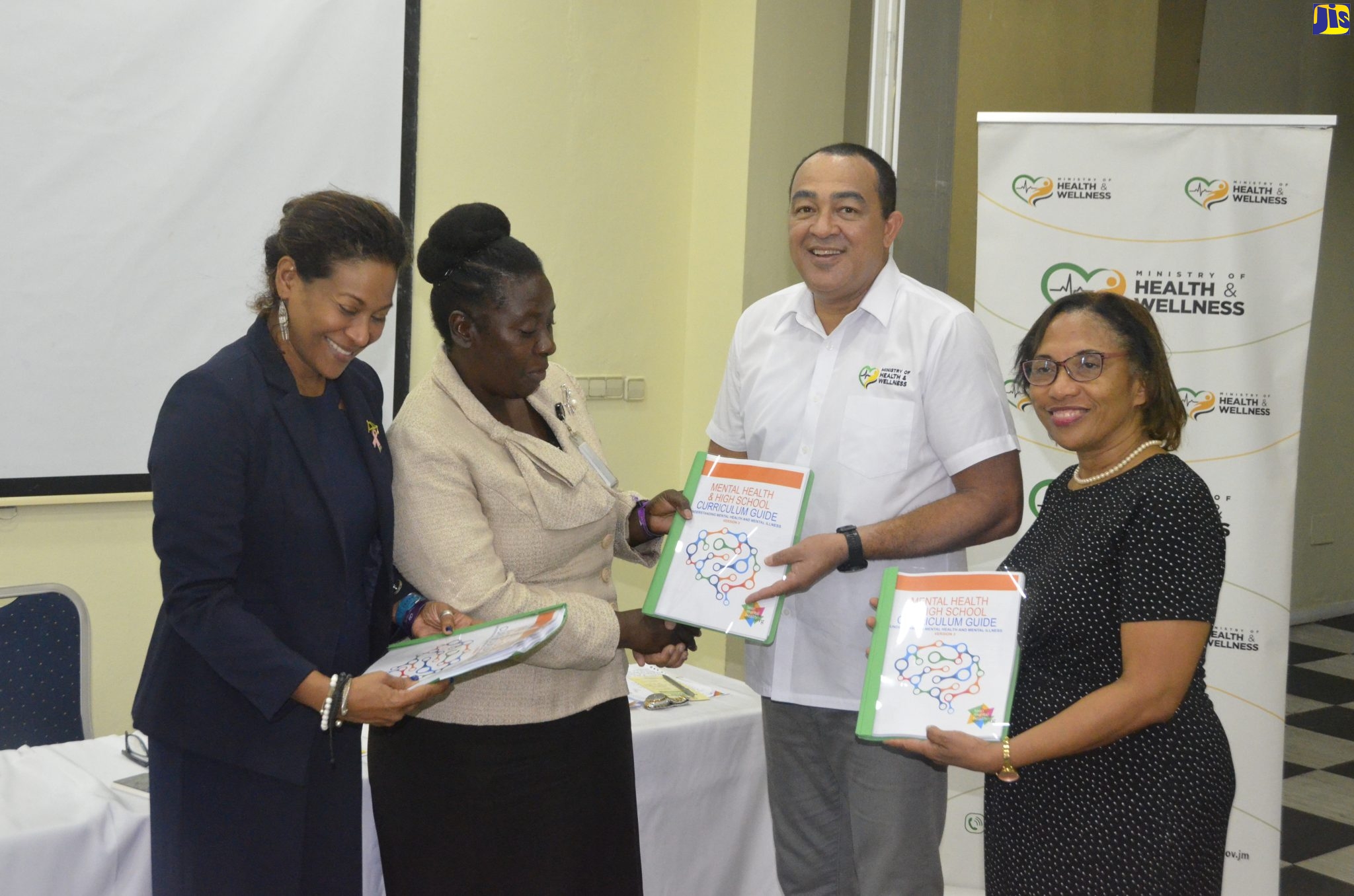 Minister of Health and Wellness, Dr. the Hon. Christopher Tufton (second right), is joined by Government Senator, Dr. Saphire Longmore (left); Director of Child and Adolescent Mental Health in the Ministry of Health and Wellness, Dr. Judith Leiba Thomas (right); and Acting Assistant Chief Education Officer at the Ministry Of Education and Youth, Kennedy Hayes Davidson, in displaying the Mental Health & High School Curriculum Guide, during the launch of the School Mental Health Literacy Programme, at Grand Palladium Jamaica Resort & Spa in Hanover, on Thursday, October 6.