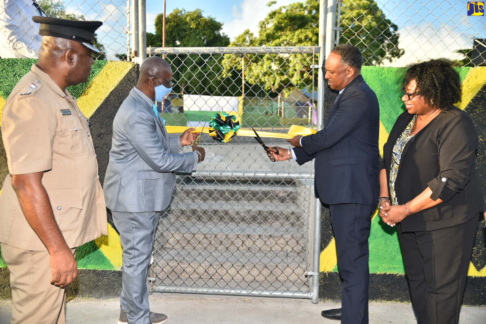Member of Parliament for Kingston Western, Hon. Desmond McKenzie (second left), and Managing Director of the Jamaica Social Investment Fund (JSIF), Omar Sweeney (second right), cut the ribbon for the official opening of the Wellington Street Park in Kingston Western on October 19, after it was retrofitted by JSIF. Sharing the moment (from left) are Senior Superintendent of Police (SSP), Michael Phipps, and Social Development Manager at JSIF, Mona J. Sue-Ho.