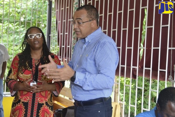 Minister of Health and Wellness, Dr. the Hon. Christopher Tufton (right), emphasises a point during discussion with Regional Psychiatrist at the Western Regional Health Authority (WHRA), Dr. Lisabeth Crossman.