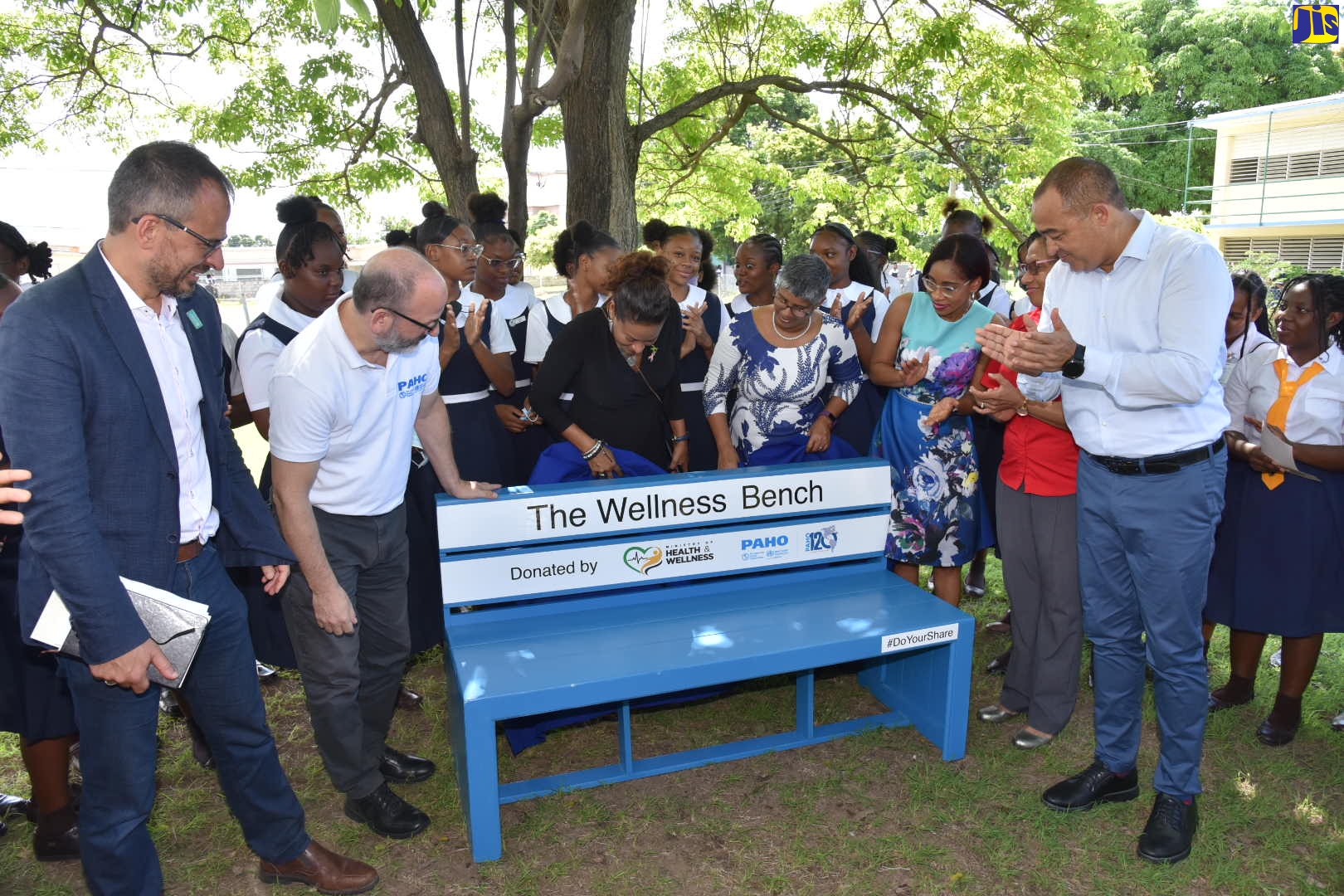 Minister of Health and Wellness, Dr. the Hon. Christopher Tufton (right), applauds following the unveiling of the wellness bench during the launch of the #DoYourShare campaign at the Convent of Mercy Academy, South Camp Road, Kingston, on October 10. Others participating (from left) are Deputy Representative, UNICEF, Vicente Teran; PAHO/WHO Representative, Jamaica, Bermuda and the Cayman Islands, Ian Stein; Government Senator, Dr. Sapphire Longmore; Principal, Convent of Mercy Academy, Kali McMorris; Mental Health Advocate, Simone Clarke-Cooper; and Director, Child and Adolescent Mental Health, Ministry of Health and Wellness, Dr. Judith Leiba; and students at the institution.