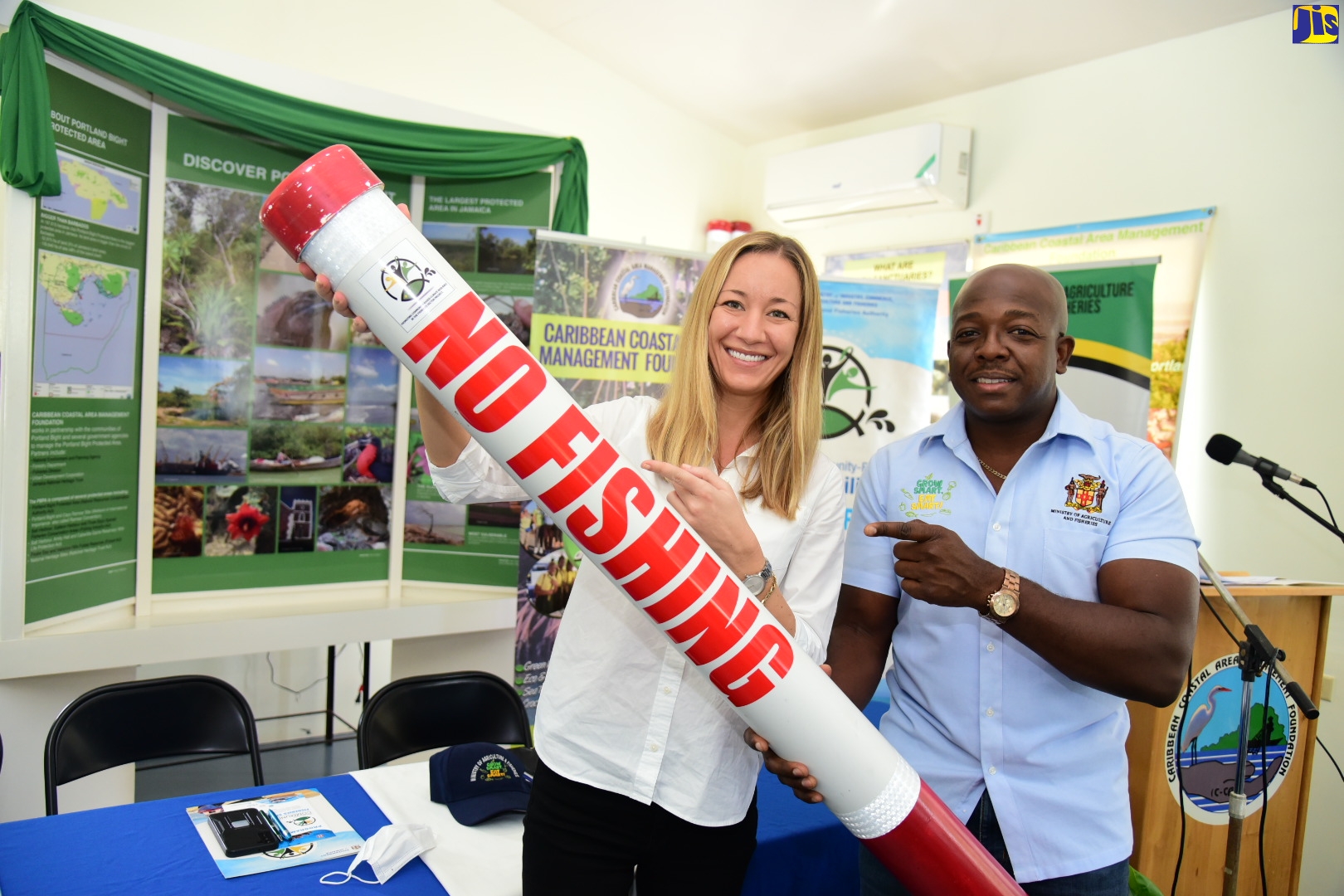 Minister of Agriculture and Fisheries, Hon. Pearnel Charles Jr. (right), and Senior Environmental Specialist with the World Bank, Maja Murisic, display one of several boundary markers for fish sanctuaries, funded by the Bank at a cost of US$7,500. Occasion was the handover of the markers on September 29, at the Caribbean Coastal Area Management Foundation (C-CAM), in Salt River, Clarendon.