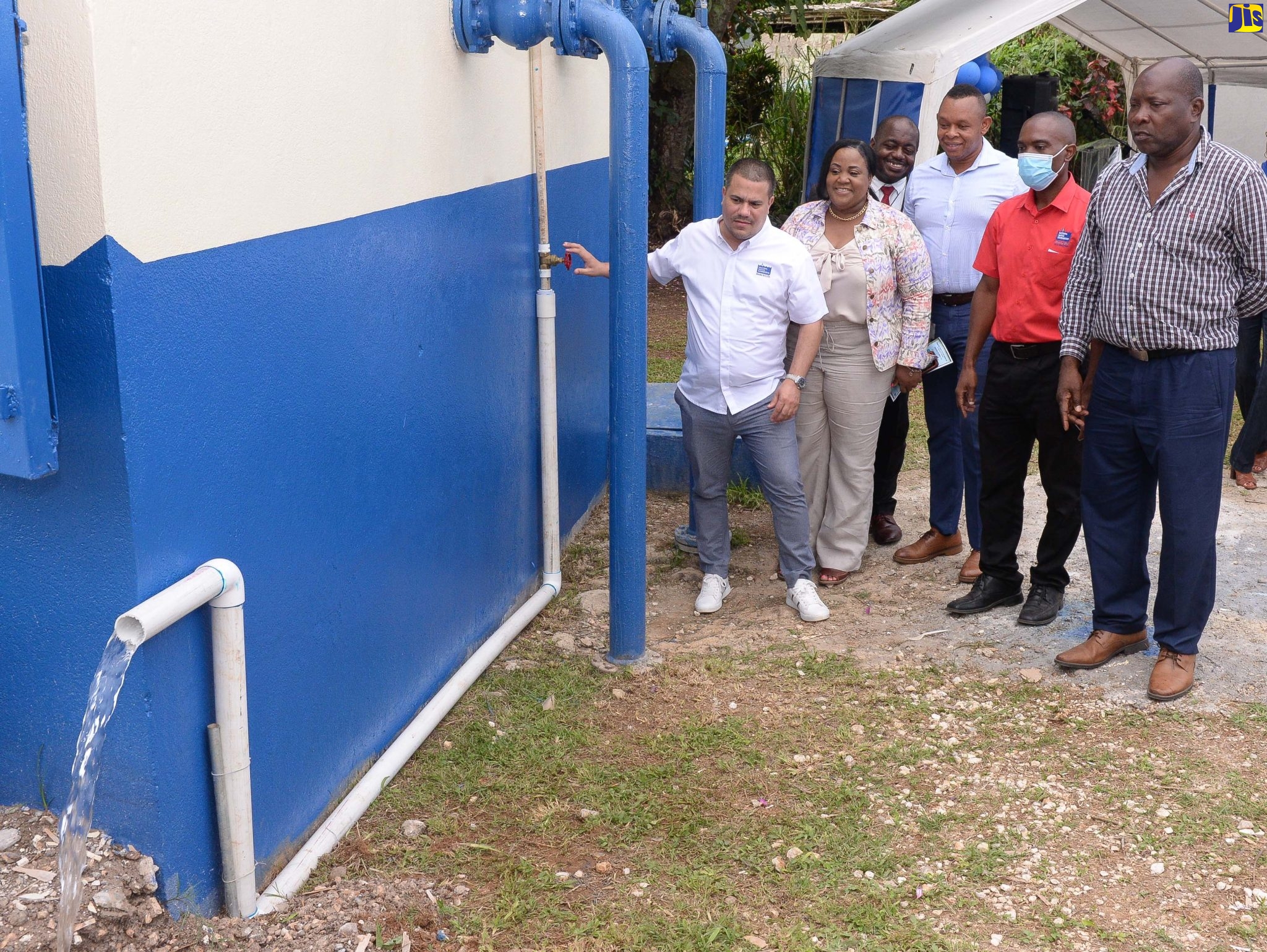 Minister Without Portfolio in the Ministry of Economic Growth and Job Creation, Senator the Hon. Matthew Samuda (left), turns on a tap symbolising the official commissioning of the National Water Commission (NWC) newly upgraded Sligoville water system in St. Catherine, on October 13. Looking on (from second left) are Member of Parliament, St. Catherine North Central, Natalie Neita-Garvey; Councillor, Sligoville Division, Dwight Burke; and NWC executives – Vice President for Operations, Kevin Kerr, Network Field Operation Manager for St. Catherine, Calvert Davis, and Regional Manager, St. Catherine/Clarendon, Garwaine Johnson. 