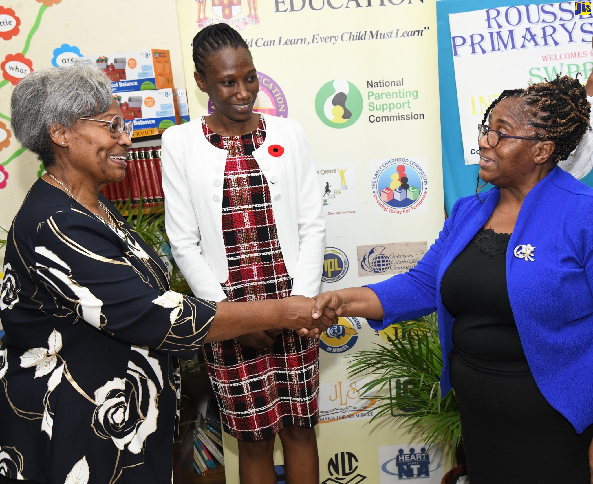 Member of the Jamaica Character Education Task Force and Founding Chief Executive Officer of Ontario Literacy and Numeracy Secretariat, Dr. Avis Glaze (left) greets Principal of Rousseau Primary School, Viviene Anderson (right), during her visit to the institution in Kingston on Tuesday, (October 18). Looking on is National Coordinator for Character Education, Simone Foster. 