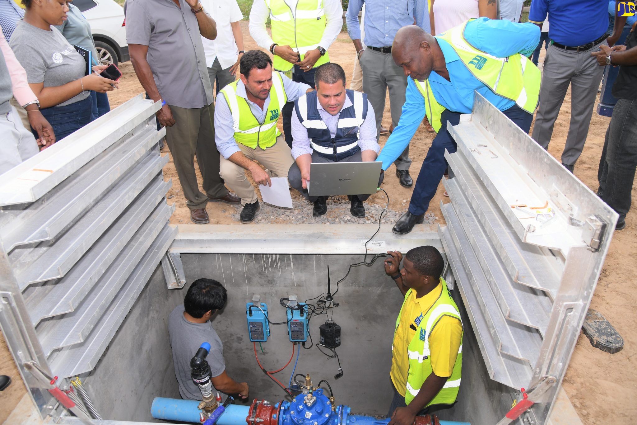 Minister without Portfolio in the Ministry of Economic Growth and Job Creation, Senator the Hon. Matthew Samuda (stooping, right), engages with the technology during a tour of the National Water Commission (NWC) Non-Revenue Water Reduction Project areas in Portmore, on Thursday (October 27). With the Minister are (from left, upper level), Miya Country Manager, Alvaro Ramalho and NWC Regional Manager, St. Catherine and Clarendon, Garwaine Johnson. Below are (from left) Miya’s Operations Manager, Wilfredo Garin and Instrumentation Technician, André Edwards.