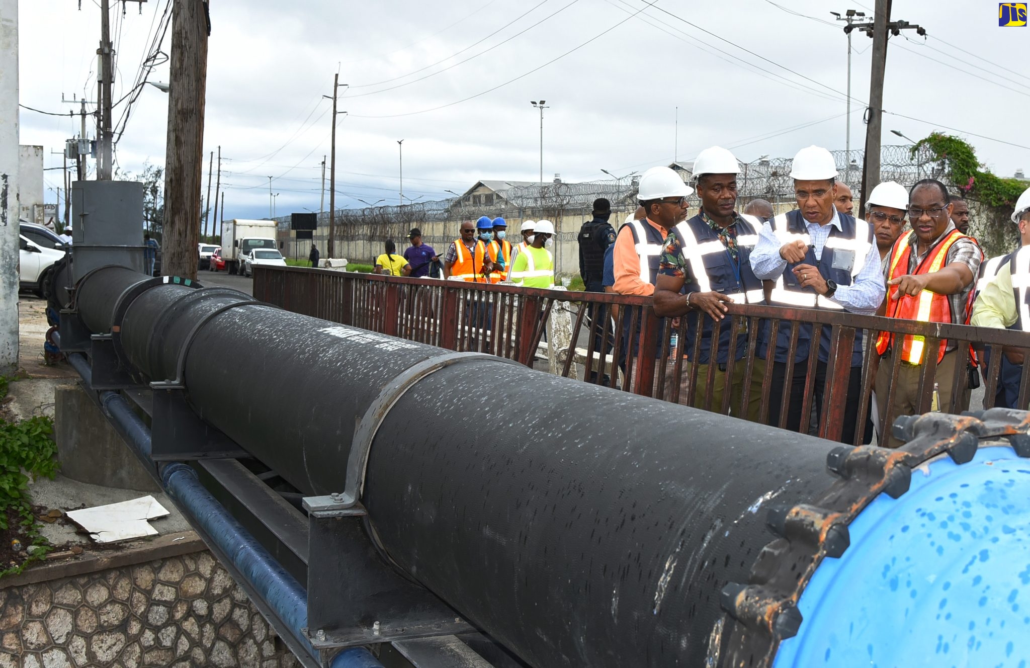 Prime Minister the Most Hon. Andrew Holness (centre), points to a section of National Water Commission’s (NWC) Spanish Town Road Potable Water Supply Transmission Main Project, in the vicinity of the Mother White Bridge, during a tour on Friday (September 30). Accompanying him are: NWC President, Mark Barnett (second left); and NWC Vice President for Engineering and Capital Projects, Garth Jackson (right).

