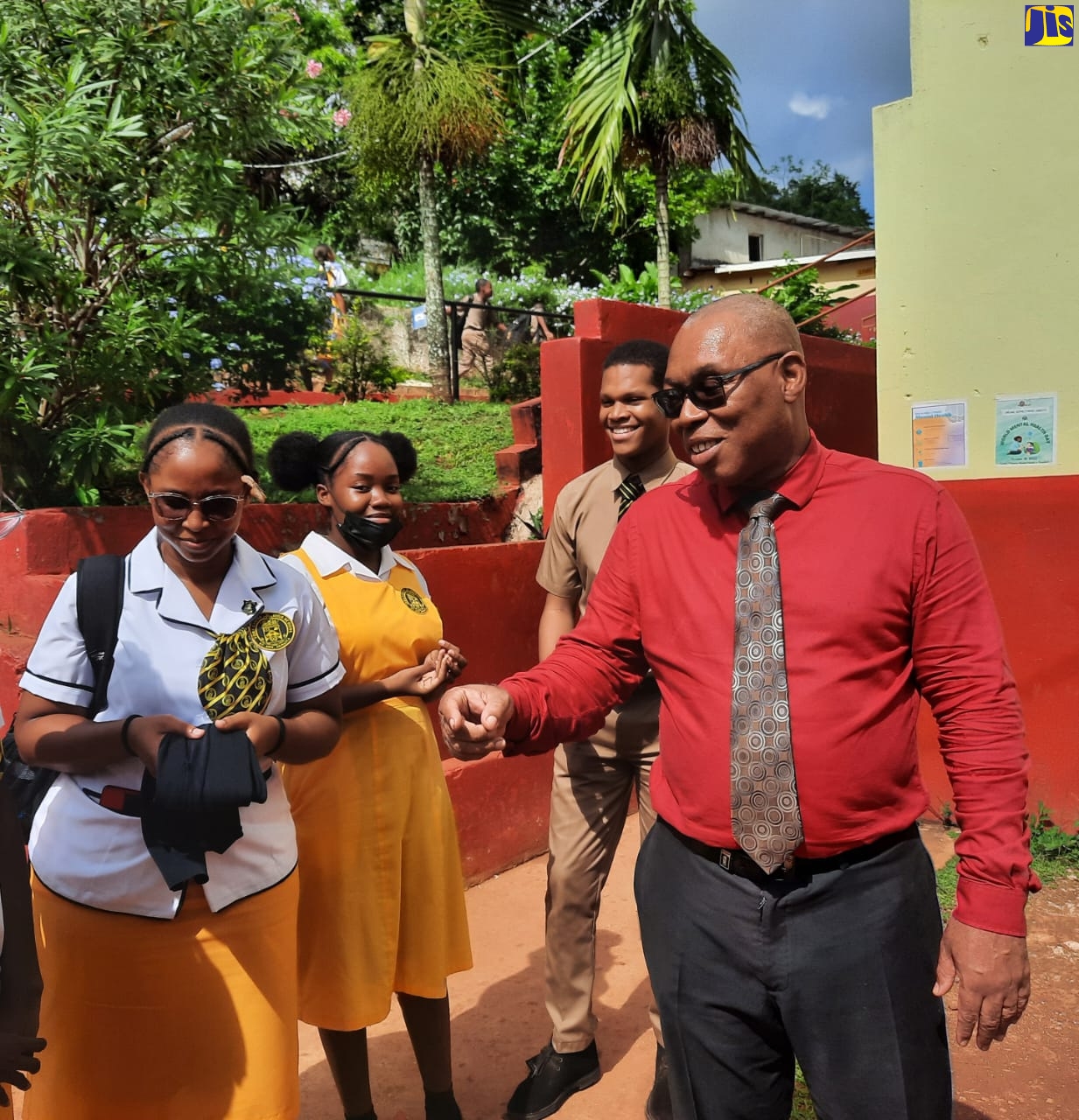 Principal of the York Castle High School, Raymon Treasure (right), converses with upper-school students (from left) Serena Palmer, Makayla McKoy, and Dajon McCalpin.
