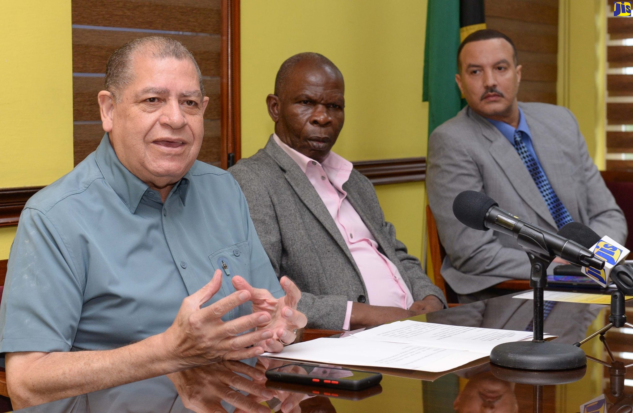 Minister of Transport and Mining, Hon. Audley Shaw (left), addresses a ceremony for the signing of a Memorandum of Understanding (MoU) to provide training for operators in the public transport sector. The signing took place on Friday (October 7), at the Ministry on Maxfield Avenue, St. Andrew. Listening are President of Transport Operators Development Sustainable Services (TODSS), Egerton Newman (centre), and Team Jamaica trainer, Chris Williams.