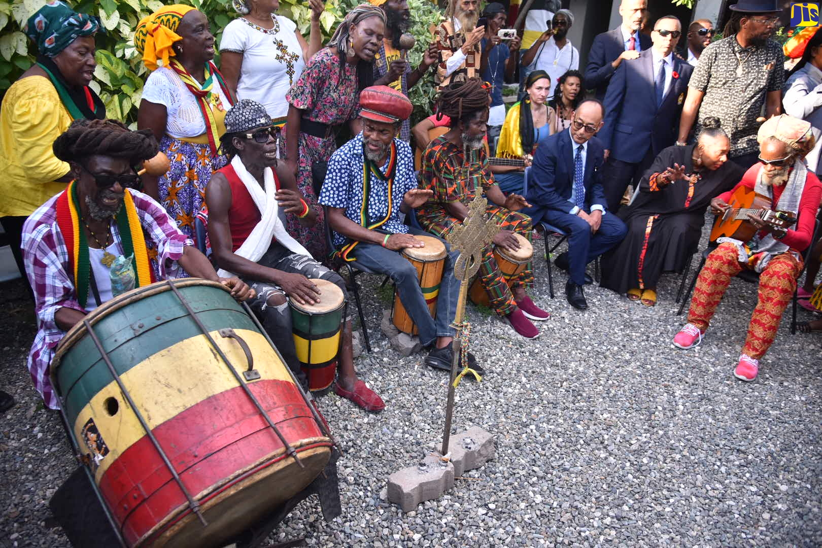 President of the Crown Council of Ethiopia, His Imperial Highness Ermias Selassie (third right, seated), being entertained by drummers while at Culture Yard in Trench Town, on October 18. Minister of Culture, Gender, Entertainment and Sport, Hon. Olivia Grange, is seated at second right.