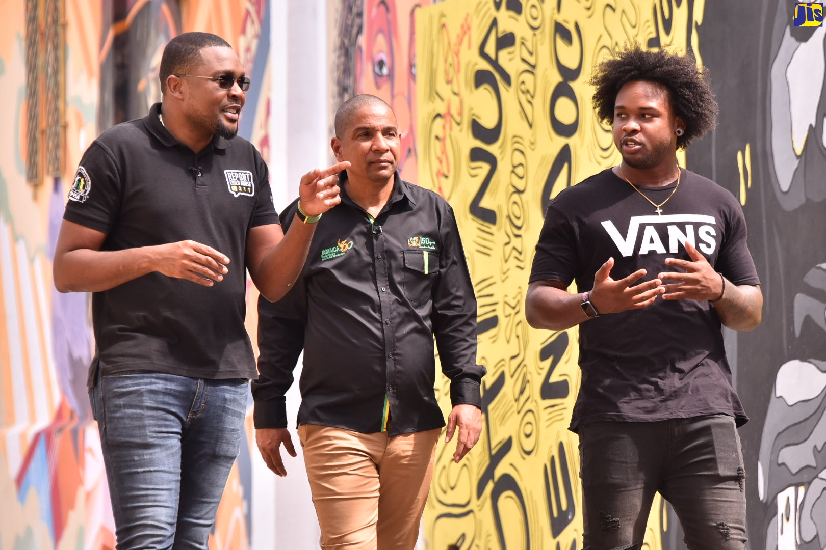 Minister without Portfolio in the Office of the Prime Minister with Responsibility for Information, Hon. Robert Morgan (left) points out something of interest to Mayor of Kingston, Senator Councillor Delroy Williams (centre), and Lead Artist, Paige Taylor, during a tour of the Kingston Creative District on Friday (October 7).