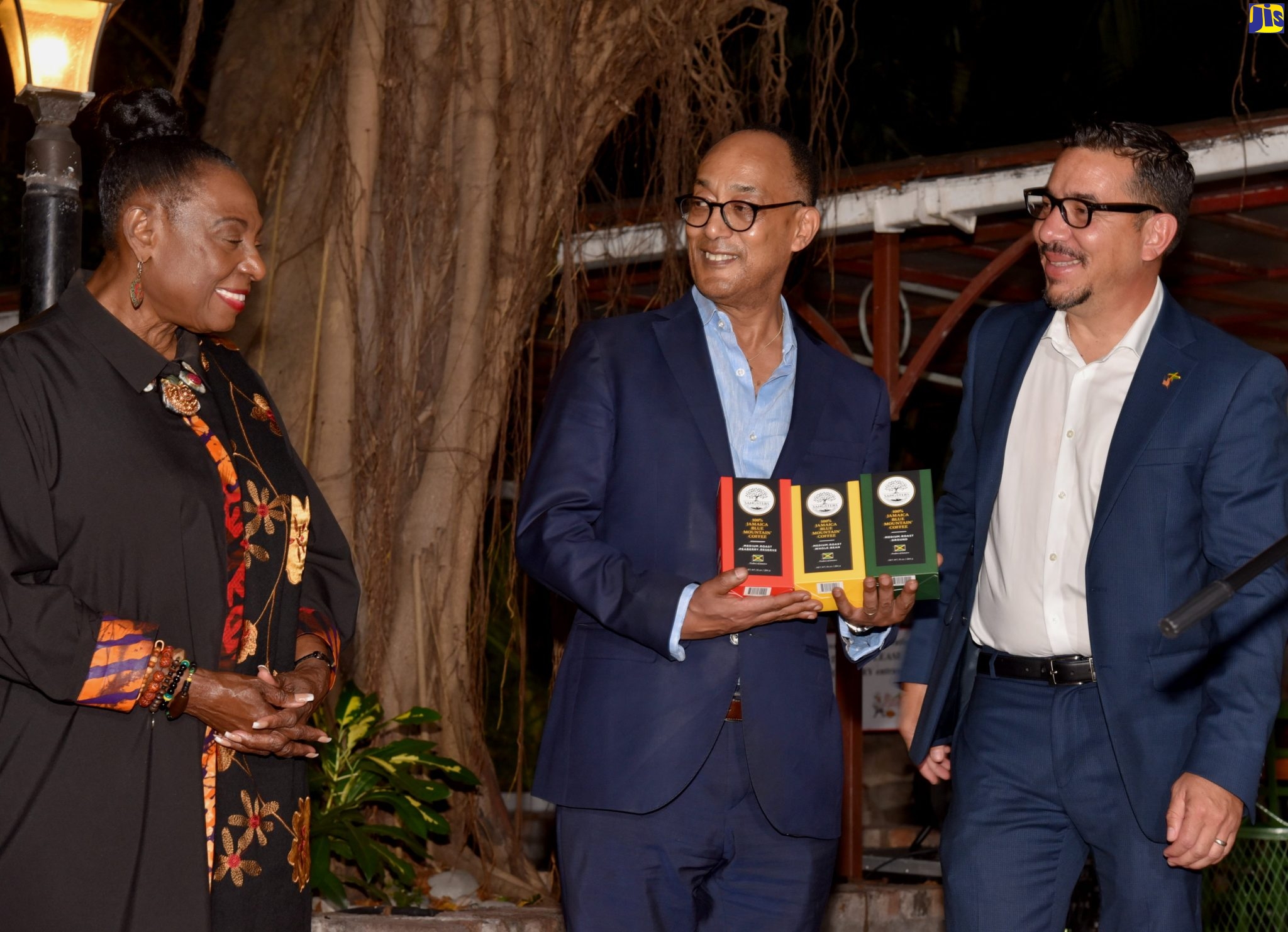 Minister of Culture, Gender, Entertainment and Sport, Hon. Olivia Grange (left) looks on as President of the Crown Council of the Federal Democratic Republic of Ethiopia, His Imperial Highness, Prince Ermias Sahle Selassie (centre), is presented with a gift of Sangster’s Blue Mountain Coffee by Chief Executive Officer at Sangster’s Coffee, Bindley Sangster II. Occasion was a reception hosted by the National Council on Reparations at Devon House in Kingston on Tuesday, (October 18).