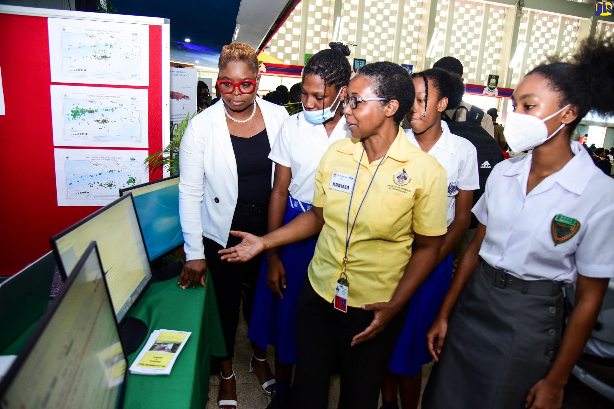Head of the Geography and Geology Department at the University of the West Indies (UWI), Mona, Dr. Sherene James-Williamson (left). listens as Scientific Officer in the UWI’s Earthquake Unit, Karleen Blake (centre), explains the Geographic Information Systems (GIS) on display, during the 20th GIS Day National Exposition on Wednesday (November 16). The event was hosted by the UWI. Students looking on (from second left) are Shoya-Kay Espeut and Shackera Wray from Buff Bay High School in Portland, and Nailah Allen from Montego Bay High School