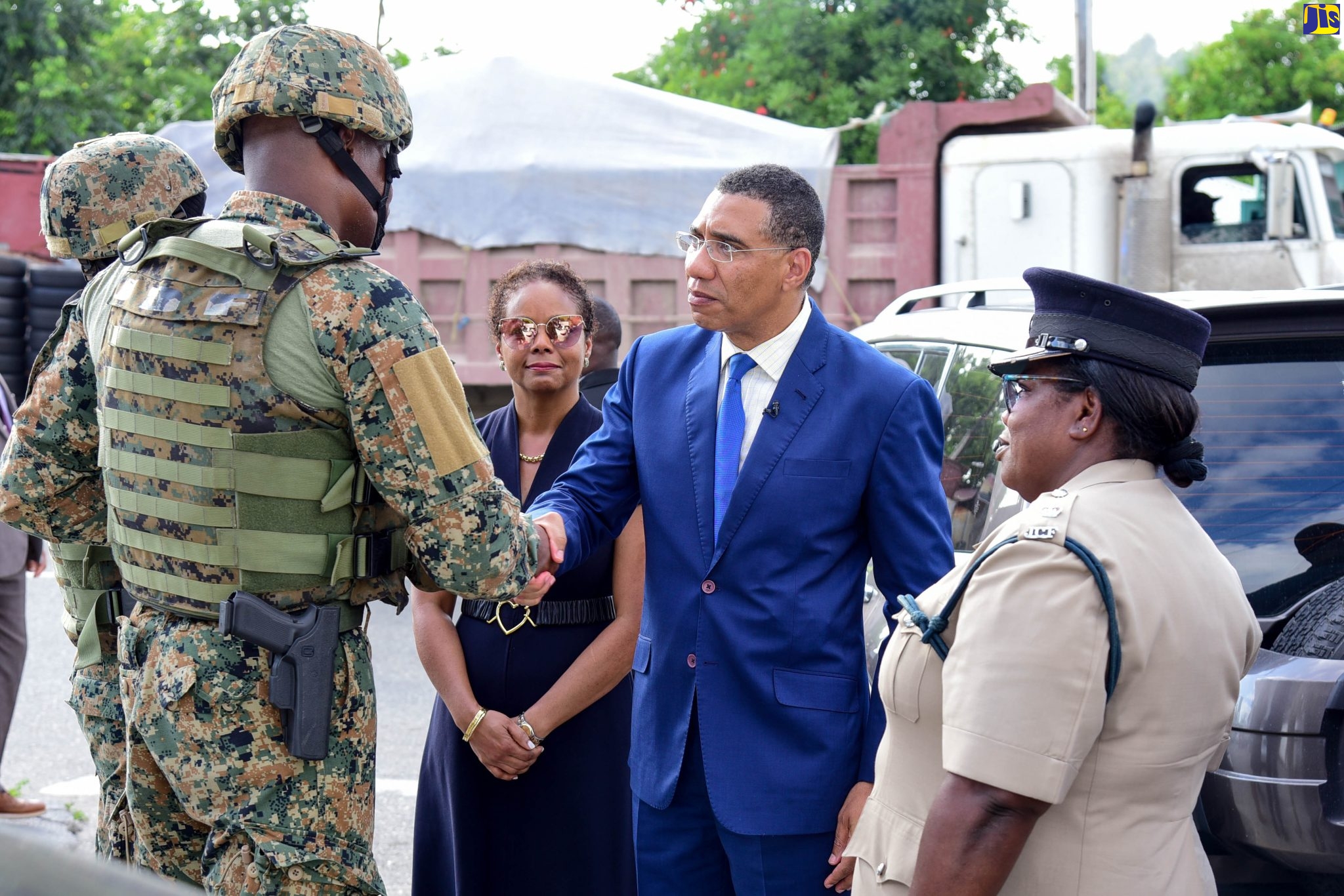 Prime Minister, the Most Hon. Andrew Holness (second right), greets a member of the Jamaica Defence Force (JDF) while visiting members of the security forces stationed at a state of public emergency (SOE) checkpoint in the Kingston Eastern Division, on Monday (November 28). With the Prime Minister are Minister of Legal and Constitutional Affairs, Hon. Marlene Malahoo Forte (third right) and Superintendent of Police, Kingston Eastern Division, Tommie-Lee Chambers (right).