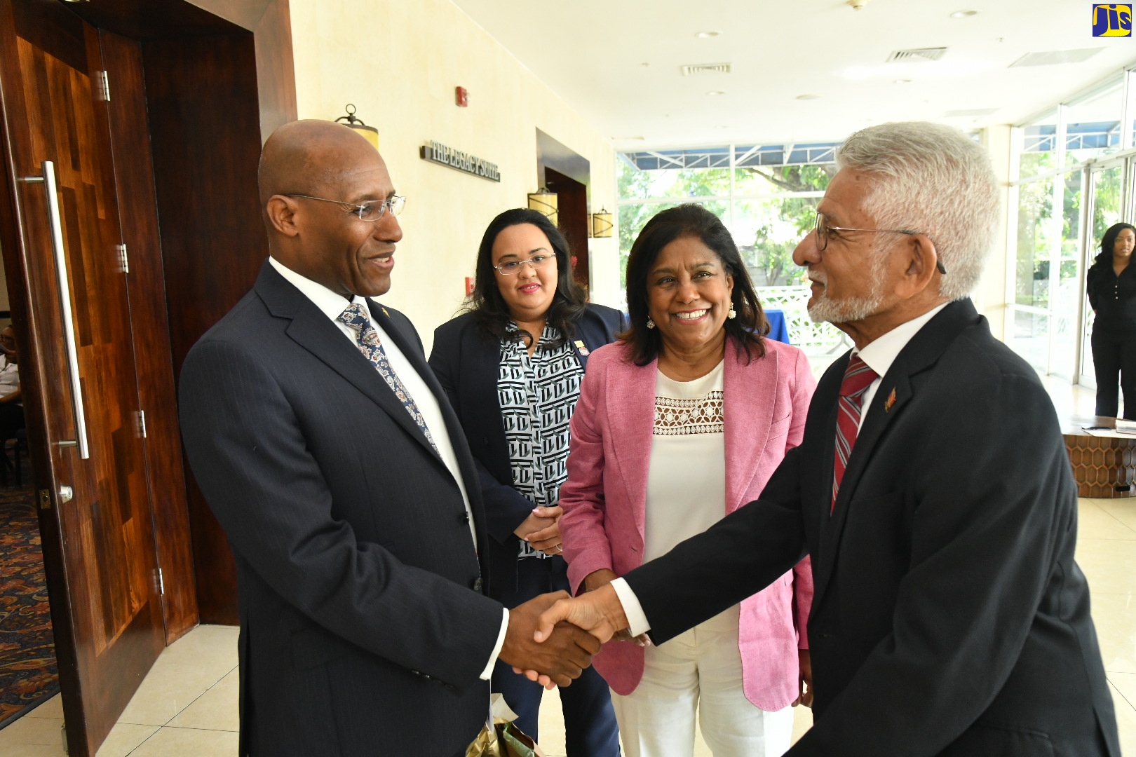 Minister of Industry, Investment and Commerce, Senator the Hon. Aubyn Hill (left), greets High Commissioner for the Republic of Trinidad and Tobago to Jamaica, His Excellency Deryck Lance Murray (right), during the Doing Business with Jamaica trade mission at The Jamaica Pegasus hotel in New Kingston on November 21. Looking on (from second left) are President of the Trinidad and Tobago Manufacturers Association (TTMA), Tricia Coosal and Minister of Trade and Industry, Trinidad and Tobago, Paula Gopee-Scoon.