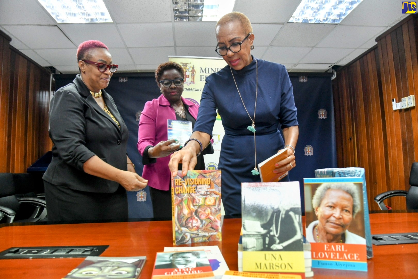 Minister of Education and Youth, Hon. Fayval Williams (right), looks at ‘Revisioning Change’ Case Studies of Curriculum in School Systems in the Commonwealth Caribbean authored by Zellynne Jennings. The book was one of several publications presented to the Minister by representatives of the University of the West Indies (UWI) Press,  at the Ministry in Kingston on Tuesday (November 22).  Looking on (from left) are Marketing and Sales Manager (Acting), UWI Press, Karen Smith; and General Manager (Acting), Nadine Buckland. The oldest and most recognised university press in the Caribbean, UWI Press is a not-for-profit scholarly publisher of more than 500 books and journals in print, audio and electronic formats.