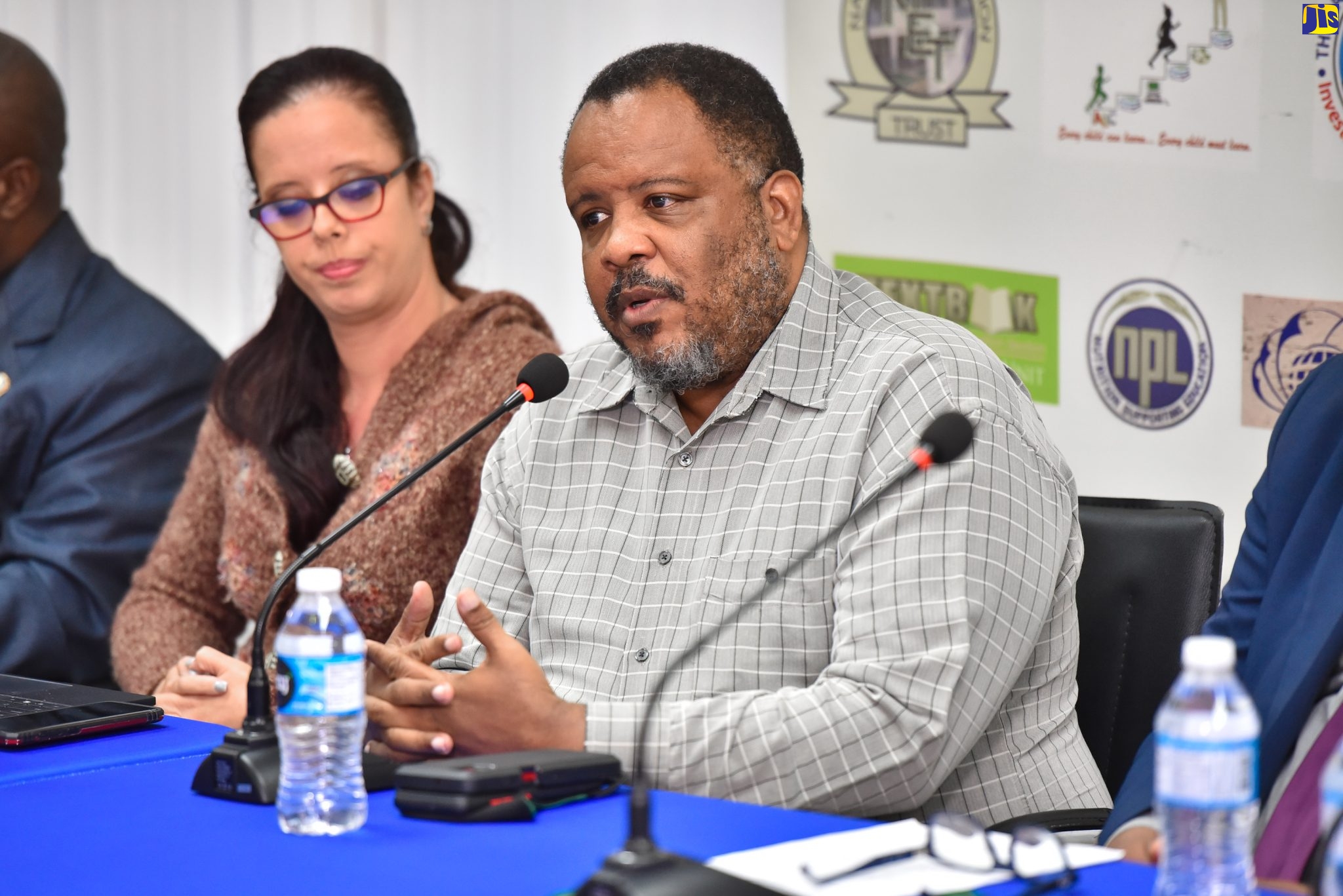 Senior Deputy Director of Public Prosecutions, Office of the Director of Public Prosecutions (ODPP), Jeremy Taylor (right), addresses the Ministry of Education and Youth’s Anti-Gang Week Town Hall on November 17, at the Office of the Commissioner of Police, Kingston, and online. At left is Deputy Superintendent of Police, Researcher, Joanna Callen.