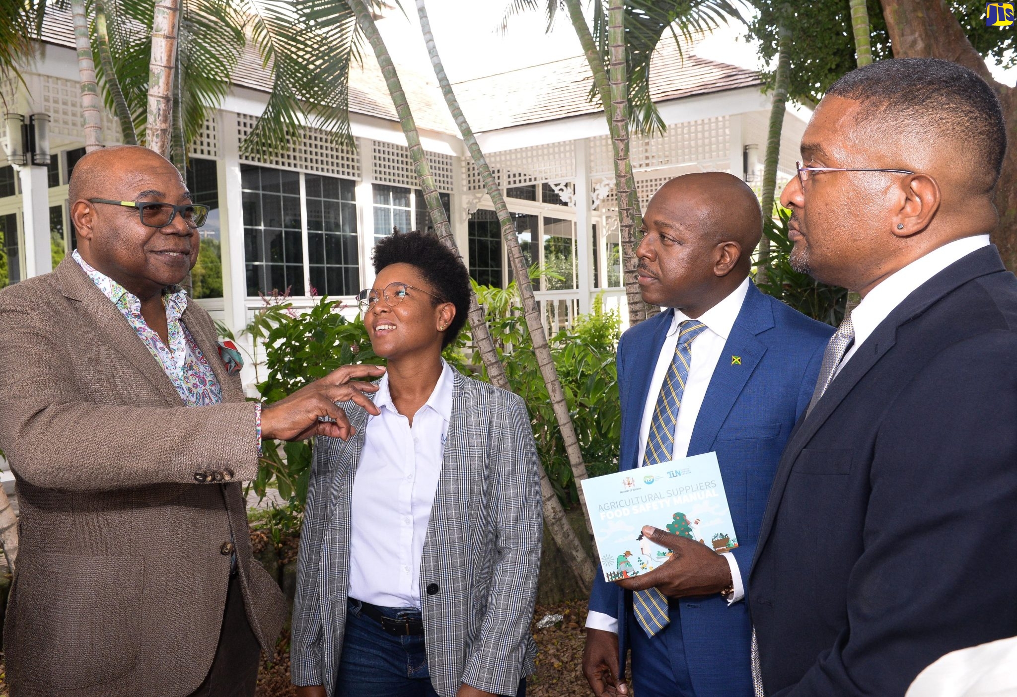 Minister of Tourism, Hon. Edmund Bartlett (left), converses with (from second left) Consultant with the Ministry, Dr. Aisha Bailey; Minister of Agriculture and Fisheries, Hon. Pearnel Charles Jr., and Chairman of the Agriculture Technical Working Group, Tourism Linkages Network,Wayne Cummings. Occasion was the launch of an Agricultural Suppliers Food Safety Manual on Wednesday (November 23) at Devon House in St. Andrew.