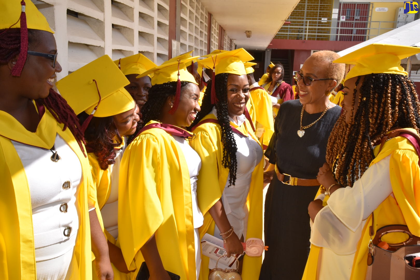Minister of Education and Youth, Hon. Fayval Williams (second right), engages with graduates of the Trench Town Polytechnic College in Kingston, during the school-leaving exercise at the institution on Wednesday (November 23). 