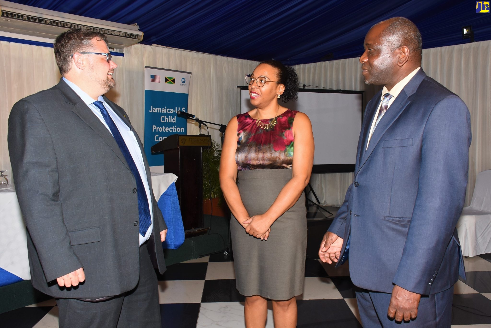 Permanent Secretary in the Ministry of National Security and Chairman of the National Task Force Against Trafficking in Persons (NATFATIP), Courtney Williams (right), in discussion with Political and Regional Team Lead from the US Embassy, Scott Winton (left) and Director for the Jamaica-US Child Protection Compact Project, Nasolo Thompson, at the recent Closing Out Ceremony for the project, at the Terra Nova All-Suite Hotel in Kingston.