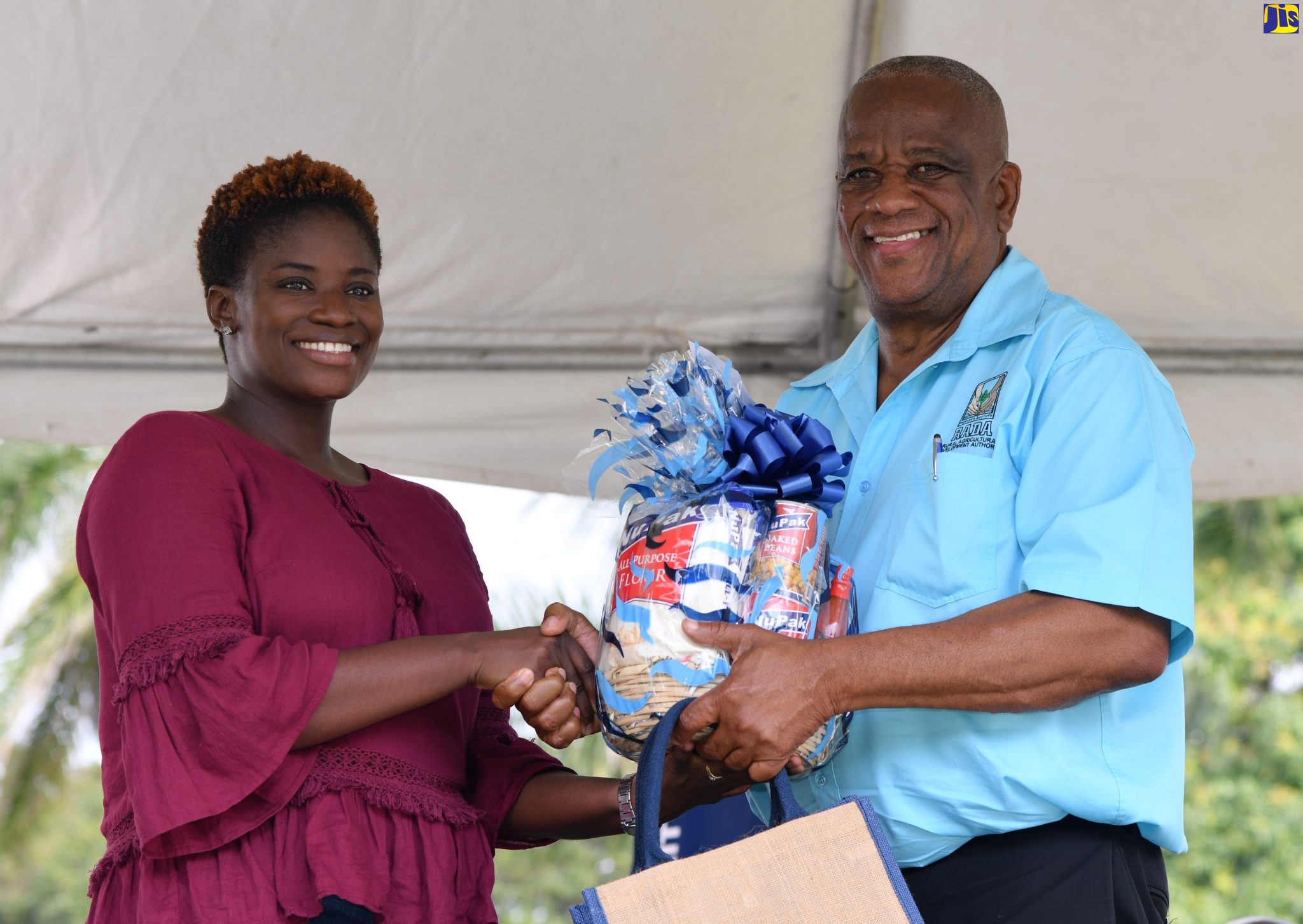 Minister of State in the Ministry of Agriculture and Fisheries, Hon. Franklin Witter (right), presents second runner-up in the ‘Many Moods of Tilapia’ cooking competition, Camelia Thompson, with her prizes. Occasion was the Eat Jamaican Day Expo at Devon House on November 25.