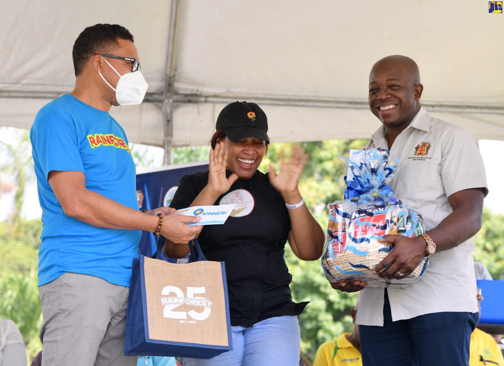 Minister of Agriculture and Fisheries, Hon. Pearnel Charles Jr. (right), and Rainforest Caribbean’s Roger Lyn (left), present an overjoyed Sasha-Kay Gooden-Petrie with her prizes for copping first place in the inaugural ‘Many Moods of Tilapia Cooking’ competition. The finals of the contest were held during the ‘Eat Jamaican Day’ Expo at Devon House on Friday (November 25).
