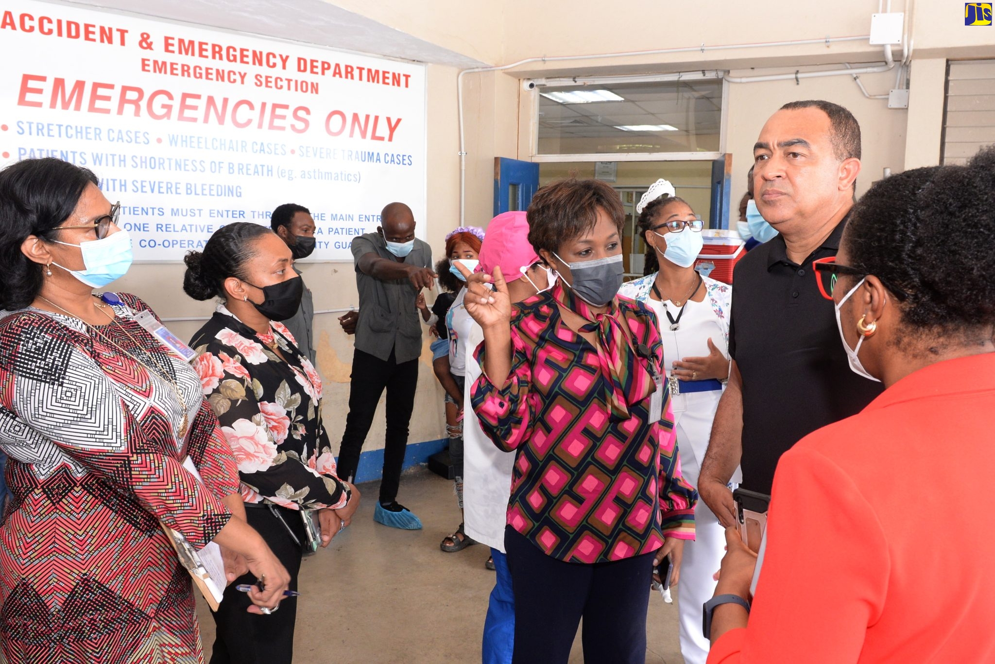 Minister of Health and Wellness, Dr. the Hon. Christopher Tufton (fourth left), listens to Senior Medical Officer (SMO) at the Spanish Town Hospital, Dr. Jacqueline Wright-James (third left), during a visit to the hospital, today (November 2). At right is Chief Executive Officer of the hospital, Jacqueline Ellis.