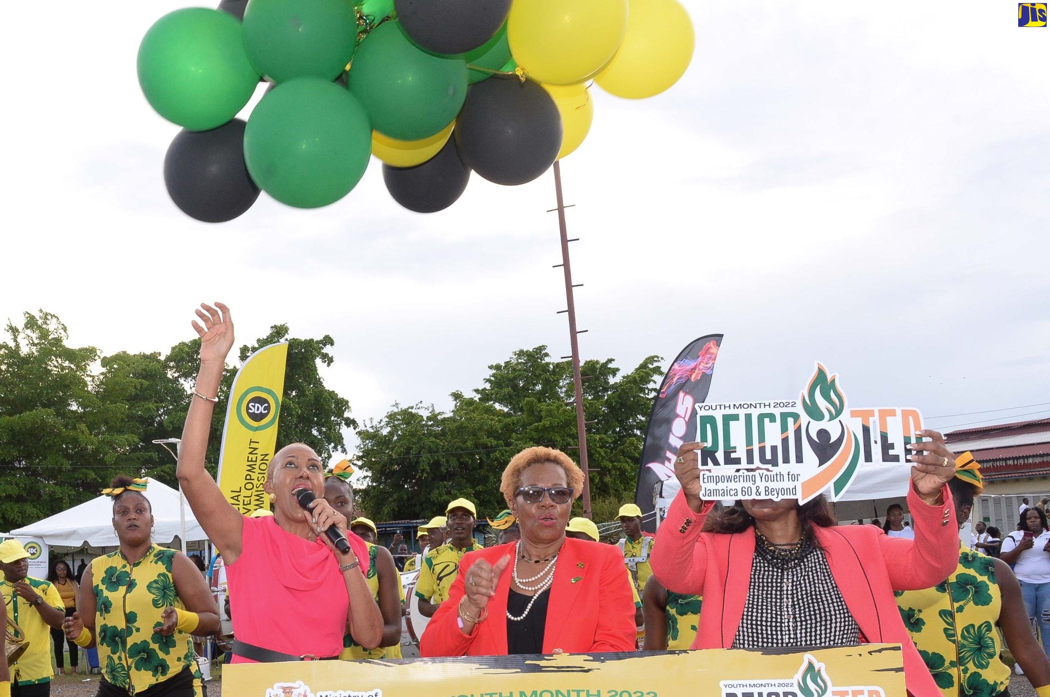 Minister of Education and Youth, Hon. Fayval Williams (left), releases a bunch of Jamaican-themed balloons while launching Youth Month (November),  at the HEART College of Construction Services in Portmore on Tuesday, November 1.  Lending support (from second left) are Permanent Secretary in the Ministry, Maureen Dwyer and Chief Education Officer (Acting), Dr. Kasan Troupe.